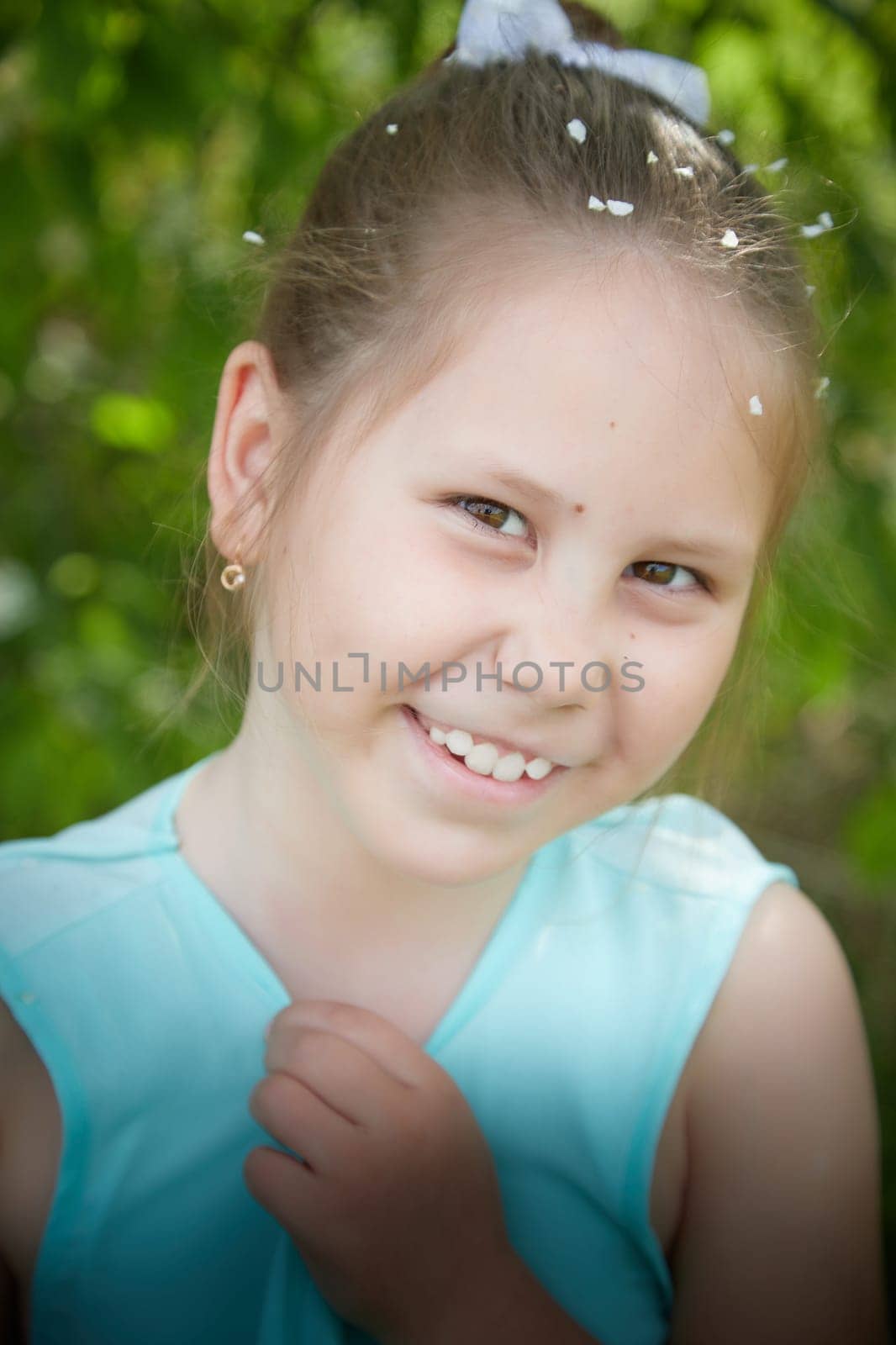 Little Happy Smiling Child Girl in blue dress on nature near greenery. SummerTime, Nature, Lifestyle, Country life by keleny