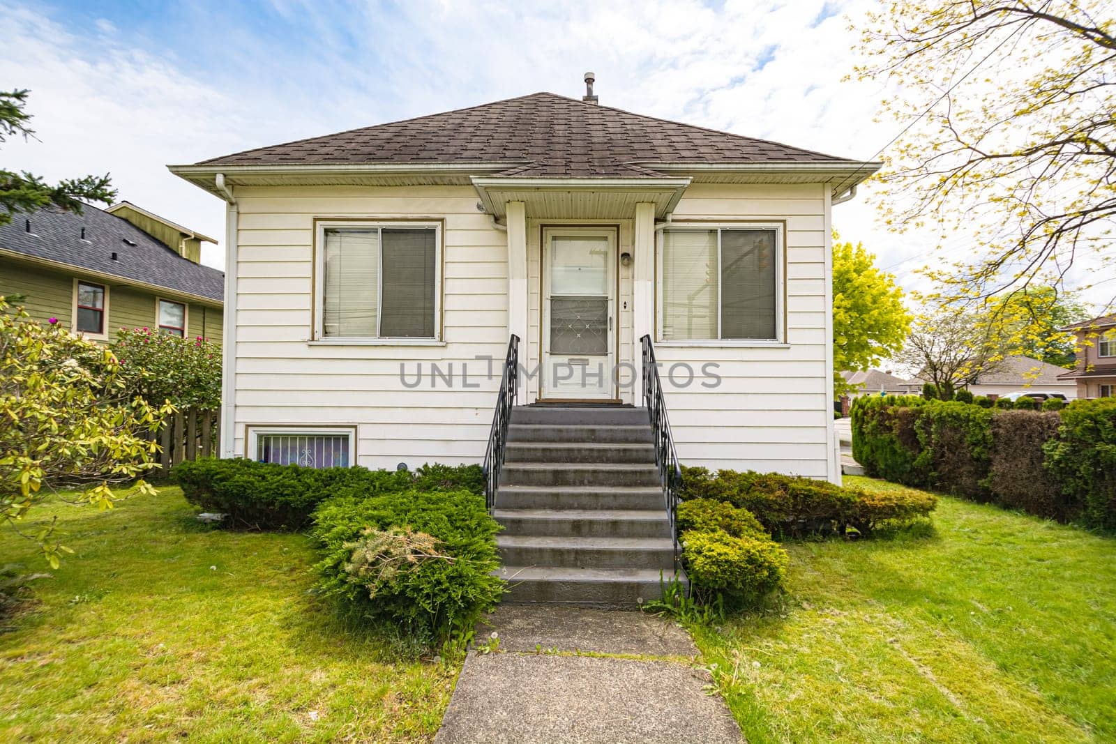 Shabby old residential house on blue sky background