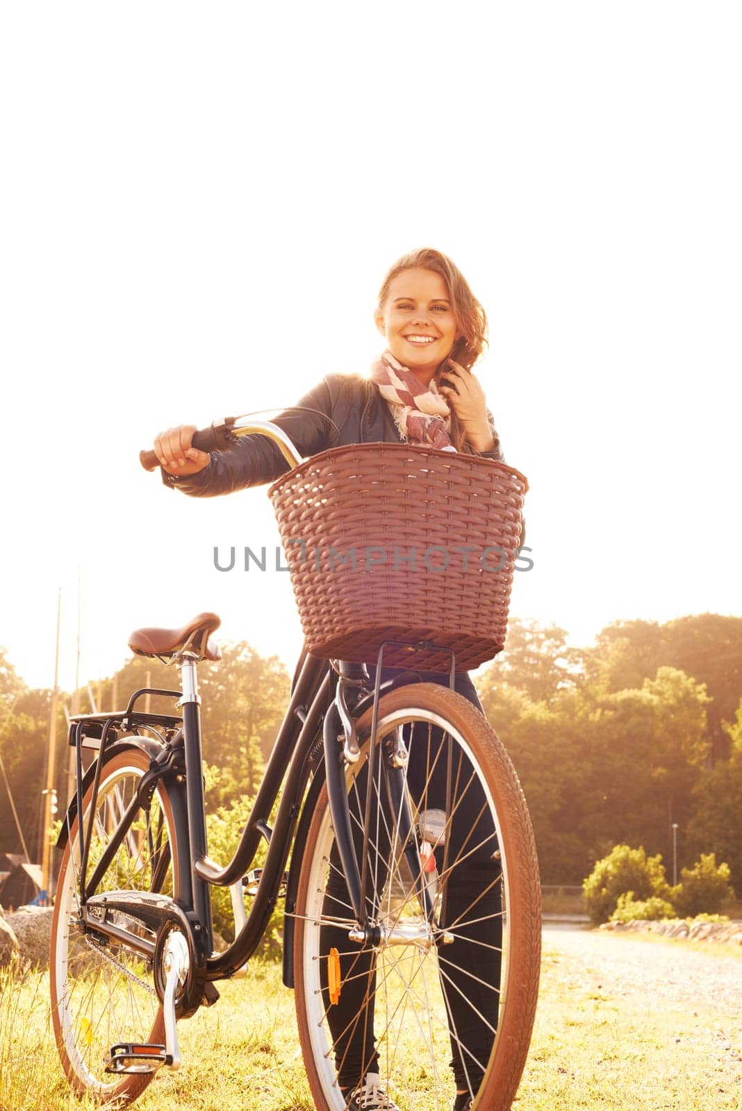 Countryside, nature and portrait of happy woman with bicycle, adventure or travel in morning. Summer, smile and bike with a basket at sunset and person in sunshine with transportation for cycling.