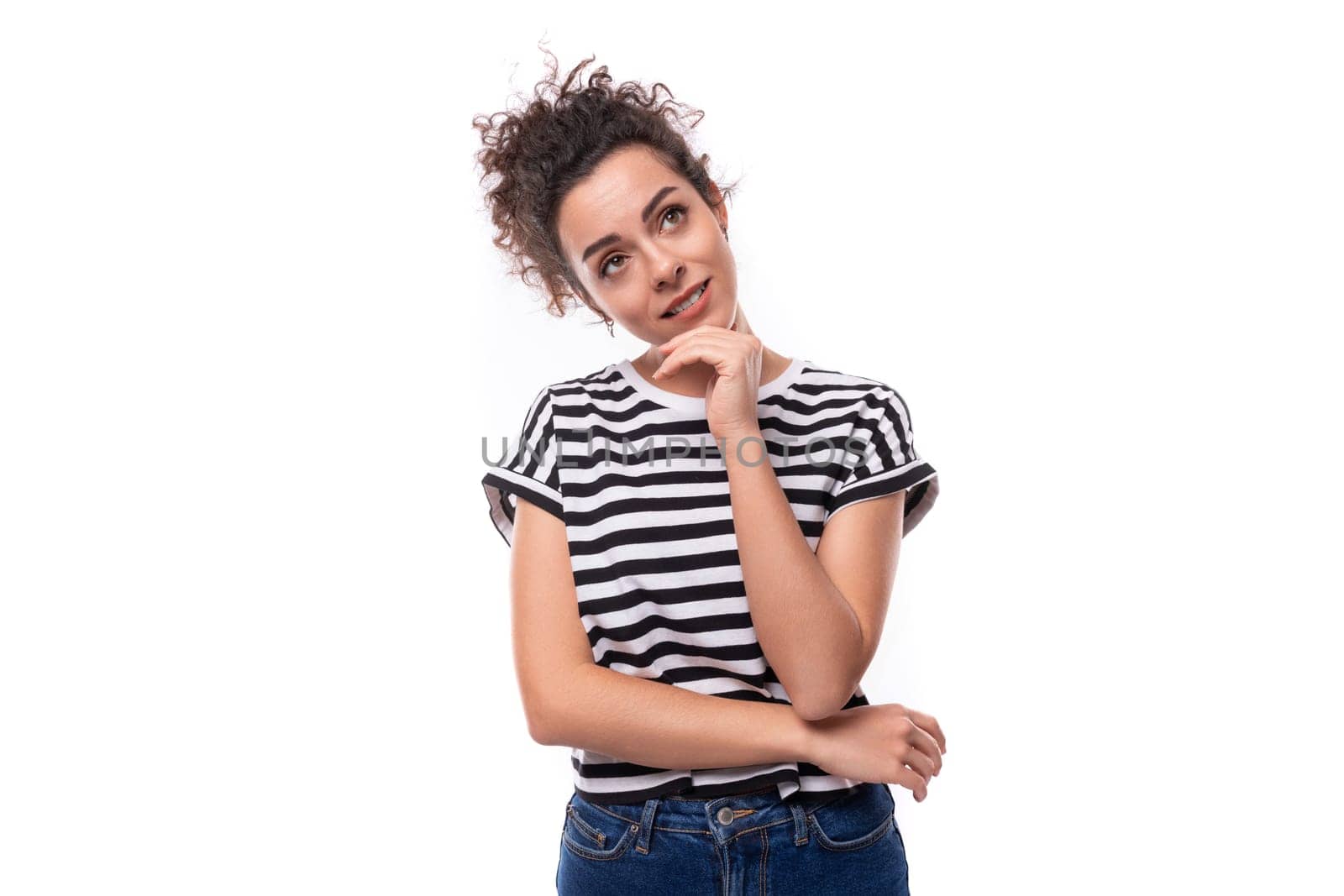 young caucasian woman with curly hair dressed in a striped summer t-shirt is brainstorming.