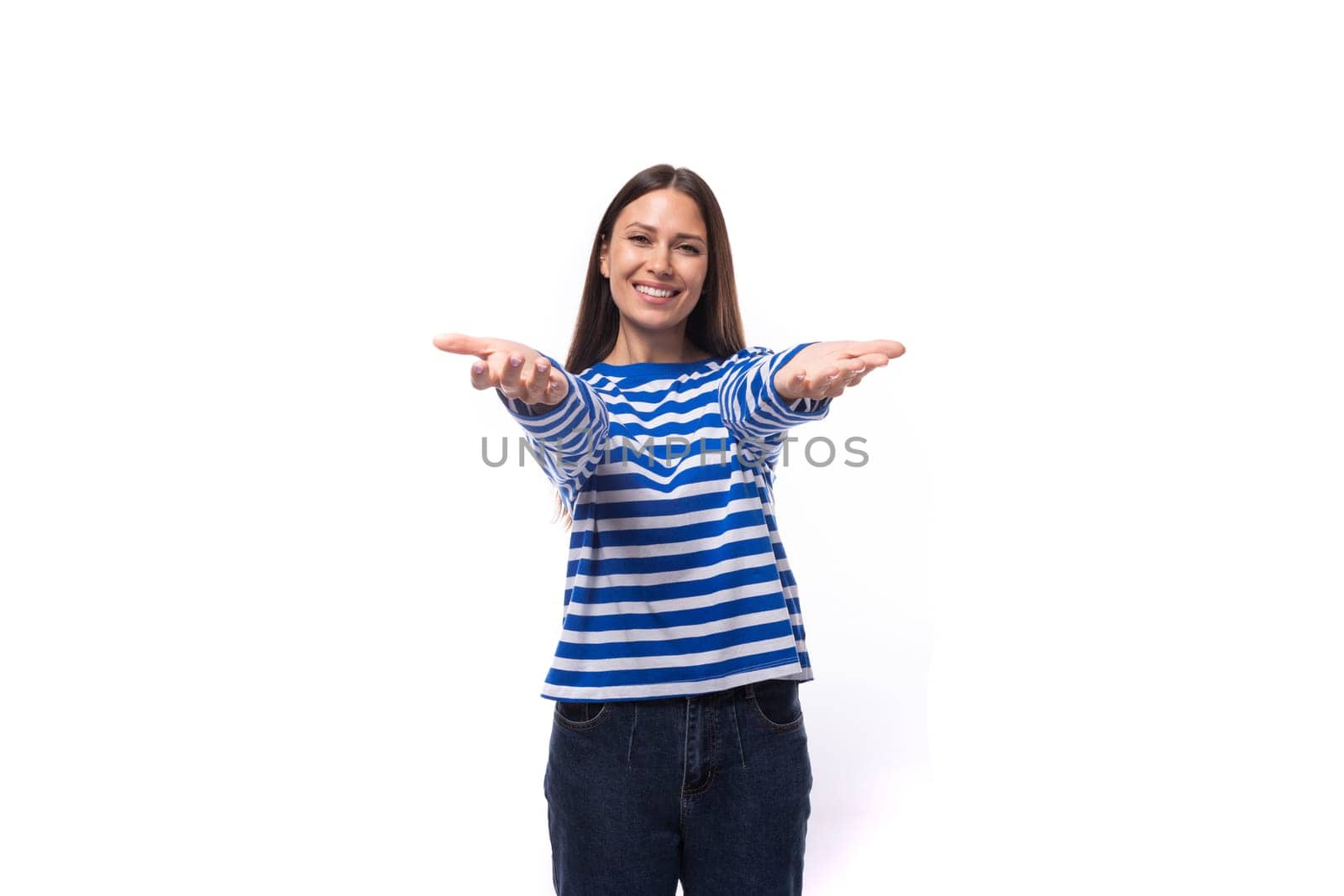 young confident european brunette woman dressed in striped blue clothes on a white studio background by TRMK