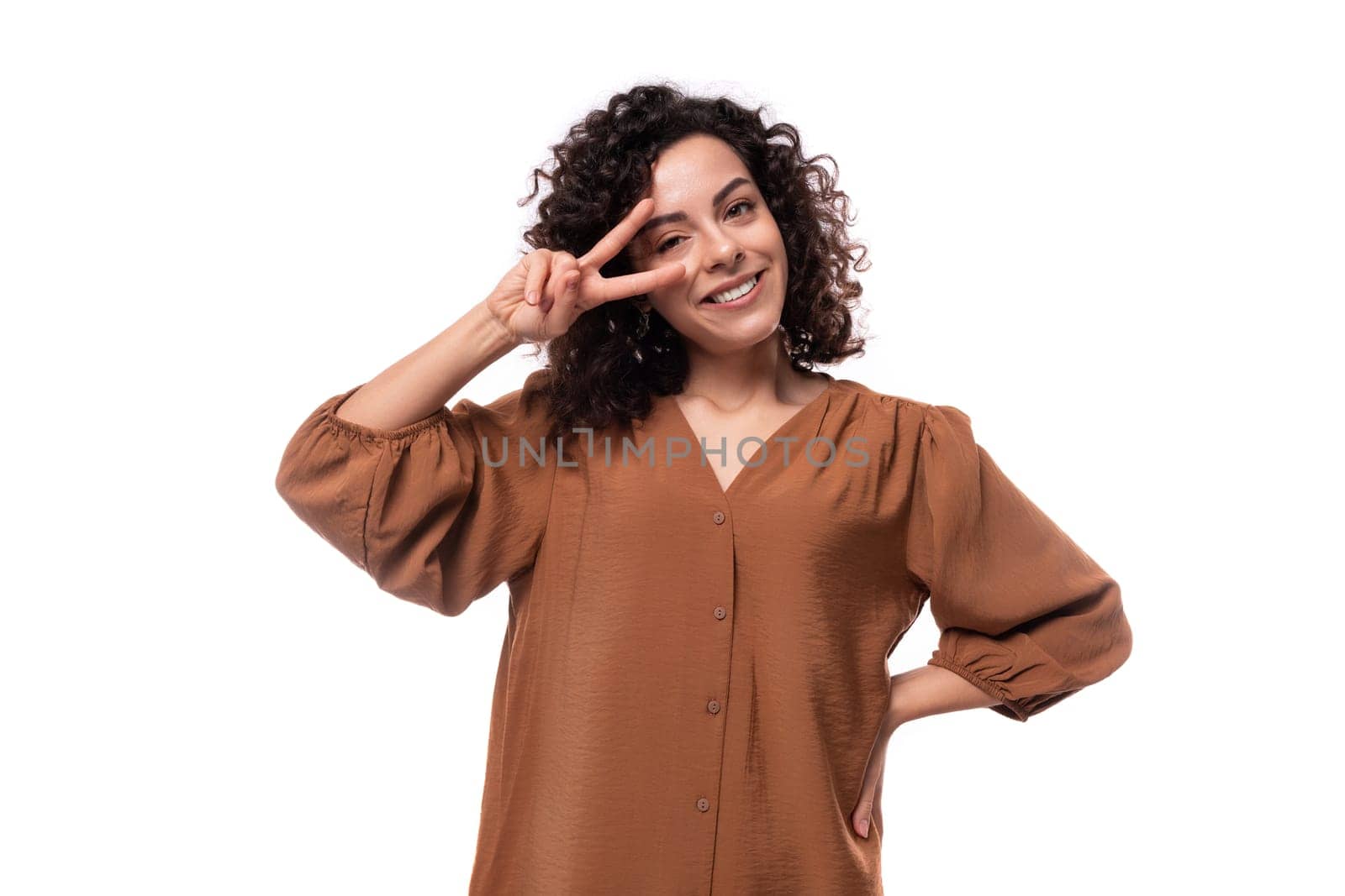 young curly businesswoman dressed in a brown blouse on a white background by TRMK