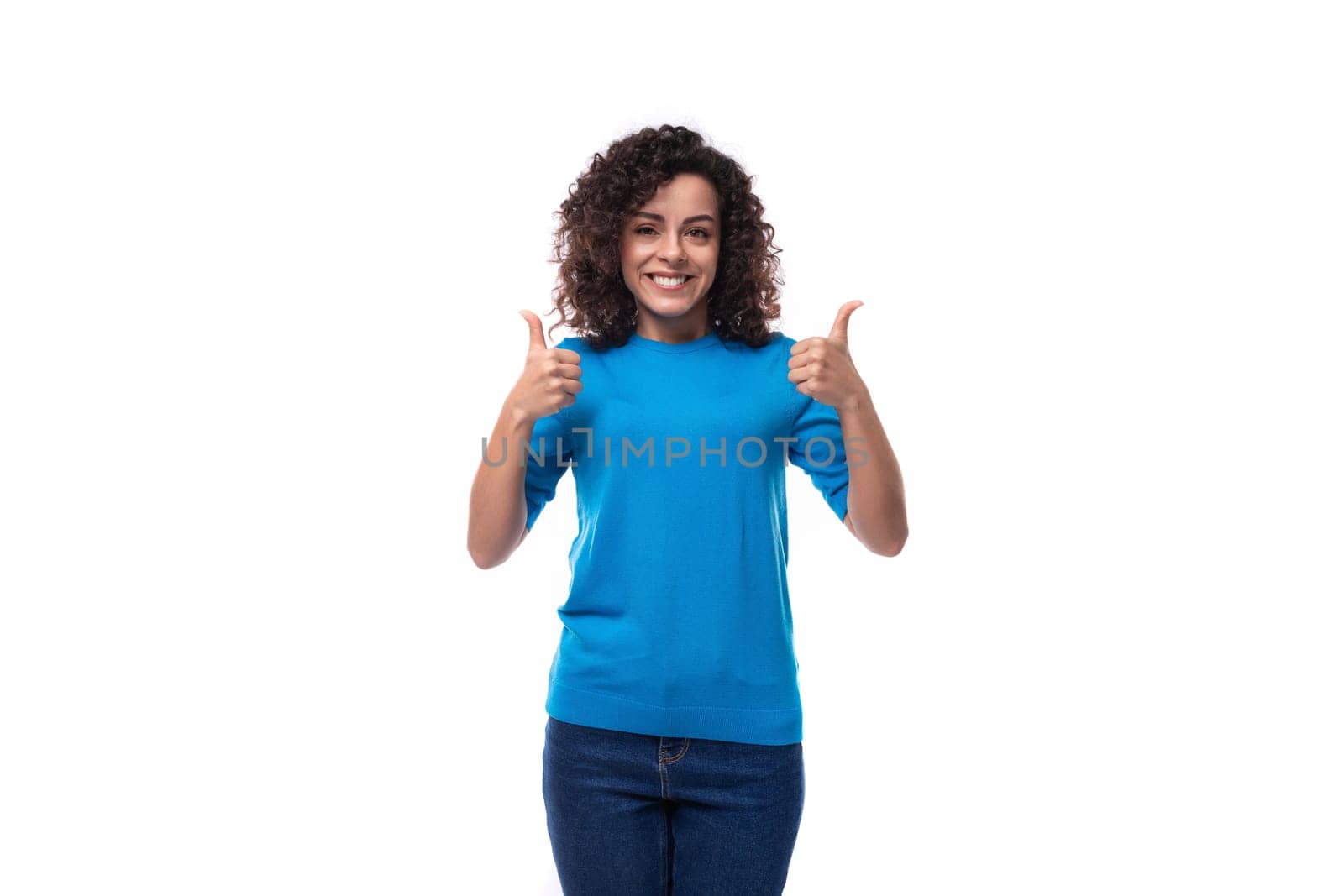 young woman with curly natural hair style dressed in a blue sweater by TRMK