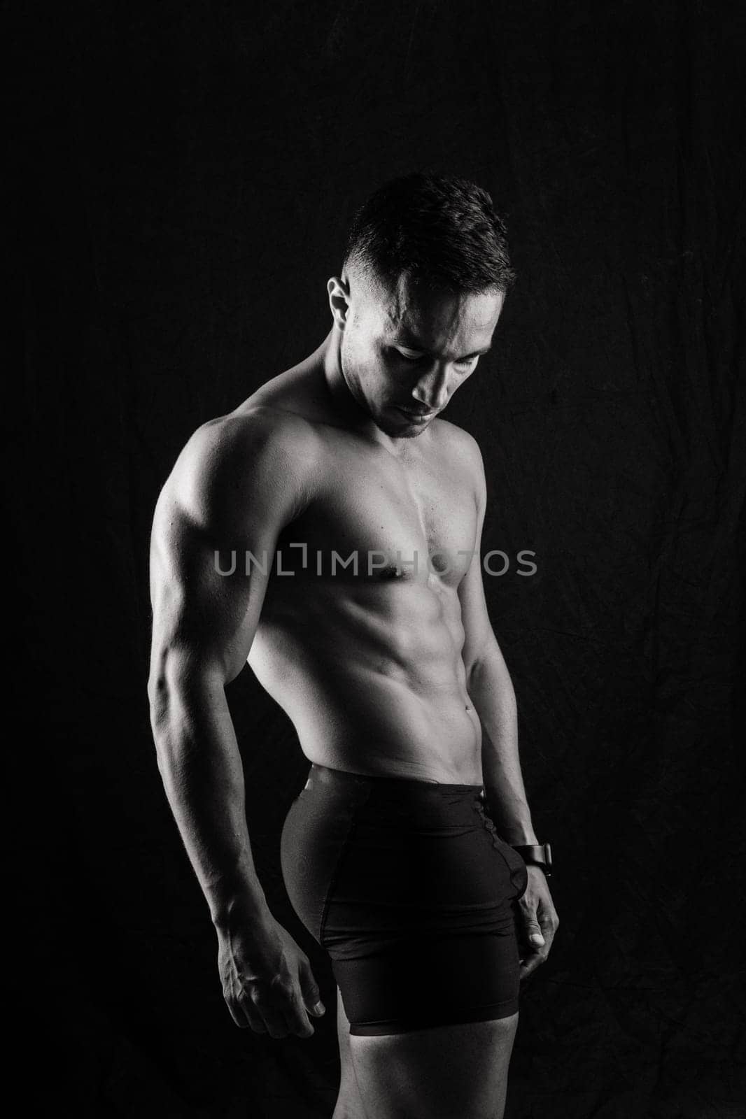 Beautiful male torso, muscular bodybuilder posing. Seductive portrait of a sport man.