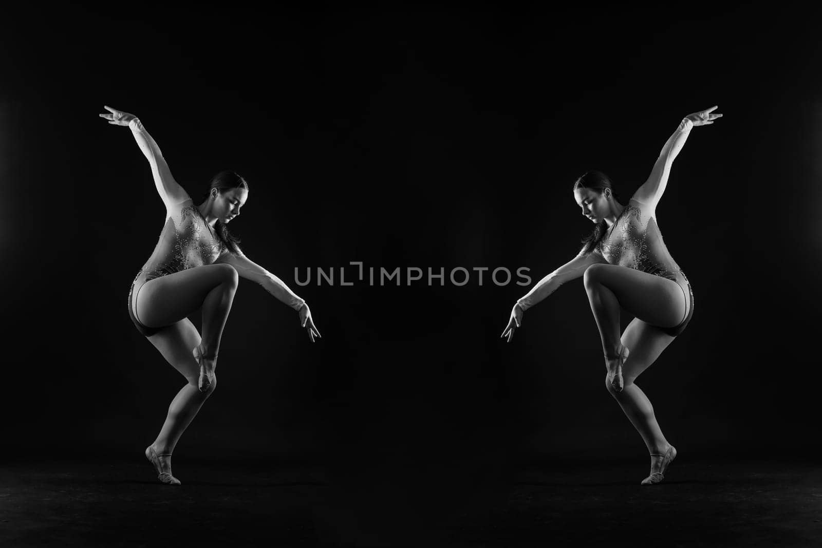 Ballet dancer in a black body paint isolated on studio background expressive artistic dance concept