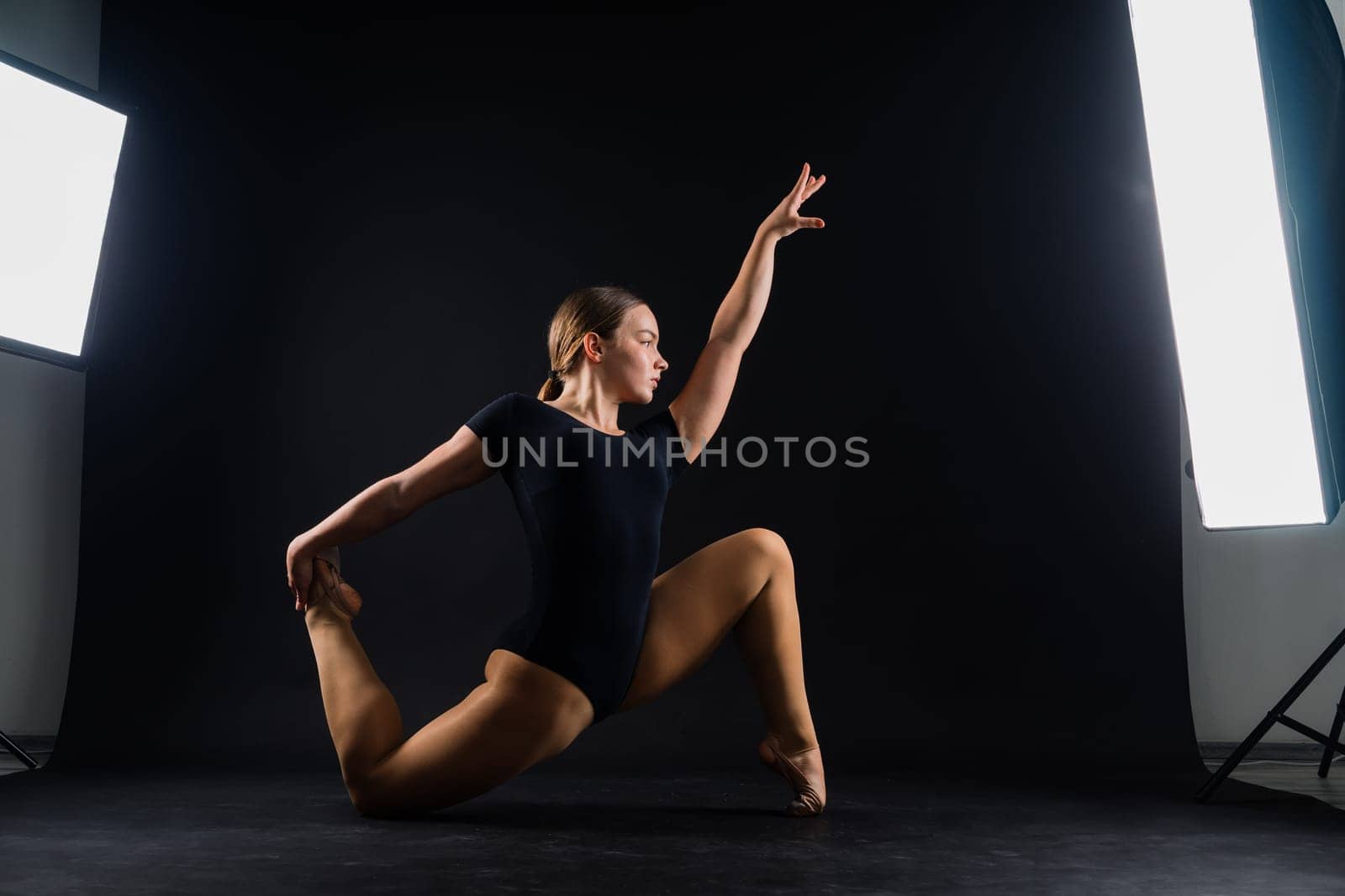 Ballet dancer in a black body paint isolated on studio background expressive artistic dance concept
