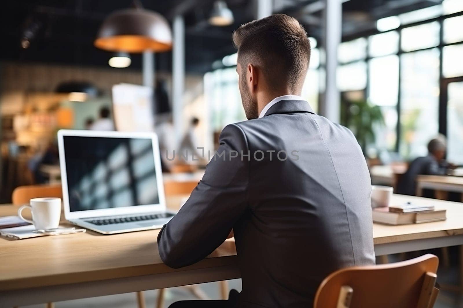 A man in a business suit with a laptop sits in a cafe. Back view. Remote work concept. Generated by artificial intelligence by Vovmar