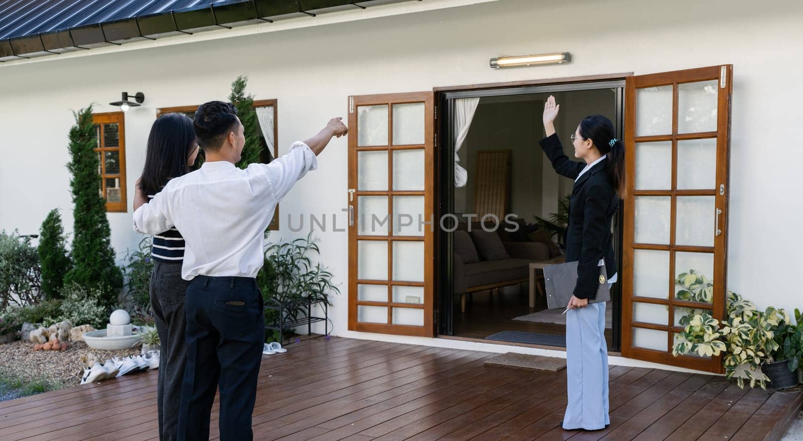 young couple with a real estate agent visiting home for buy or for rent.