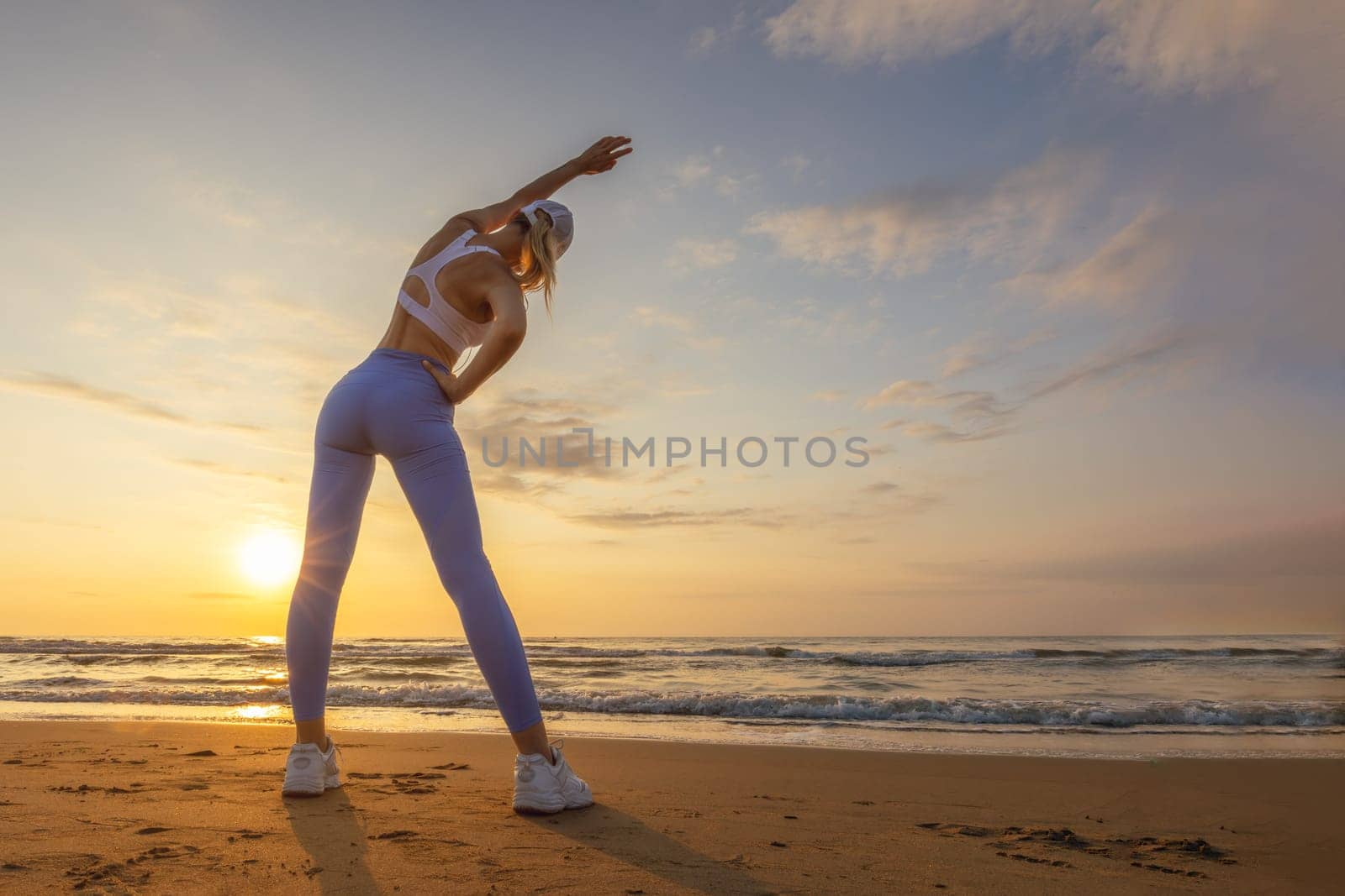 silhouette of a girl in sportswear on the sea at dawn, there is a place for an inscription. High quality photo