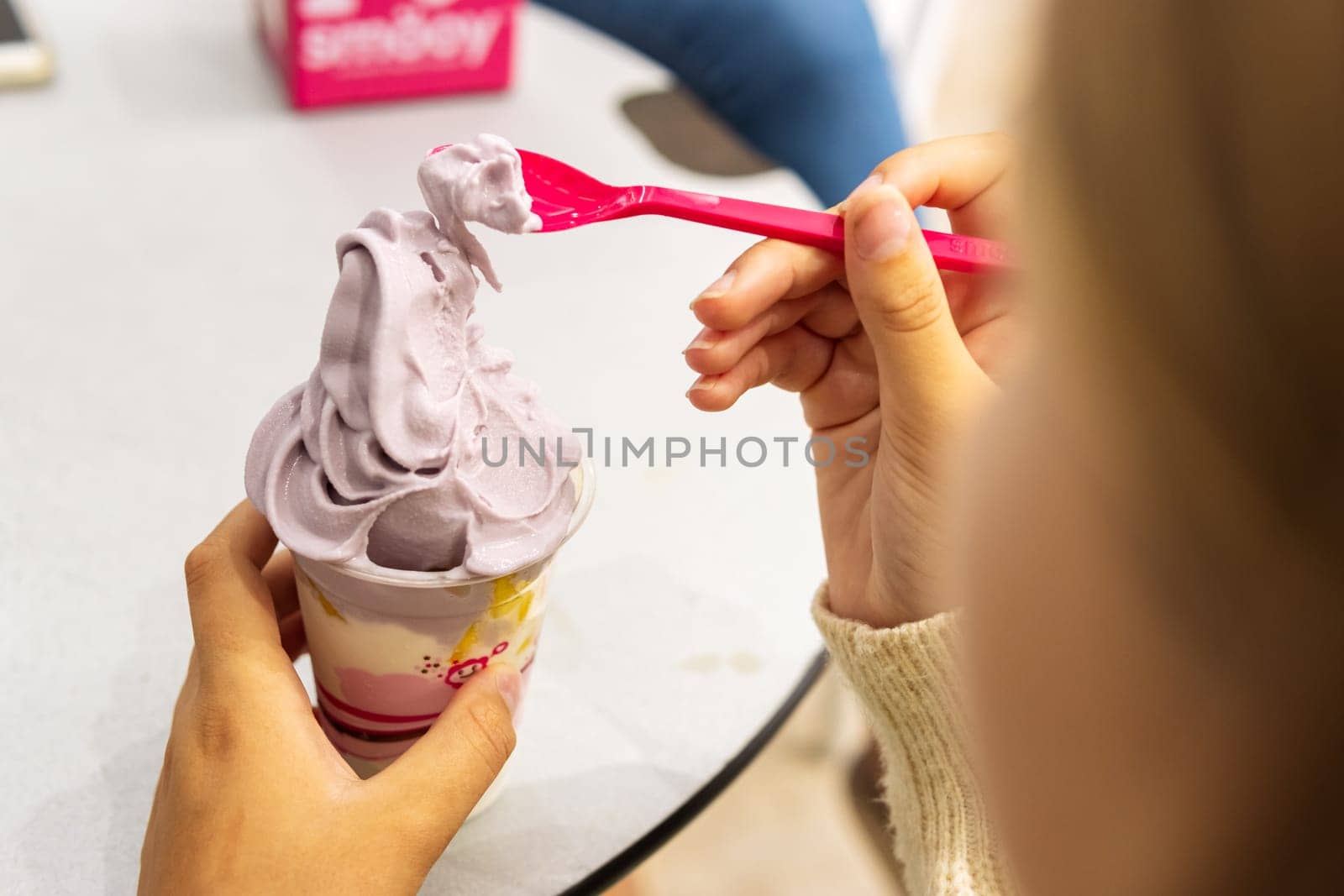 child girl eats ice cream at the table close-up on ice cream, there is a place for an inscription by PopOff