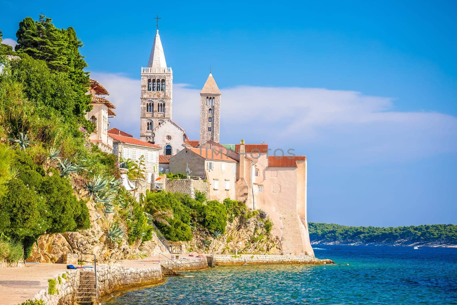 Historic town of Rab towers and beach walkway view by xbrchx