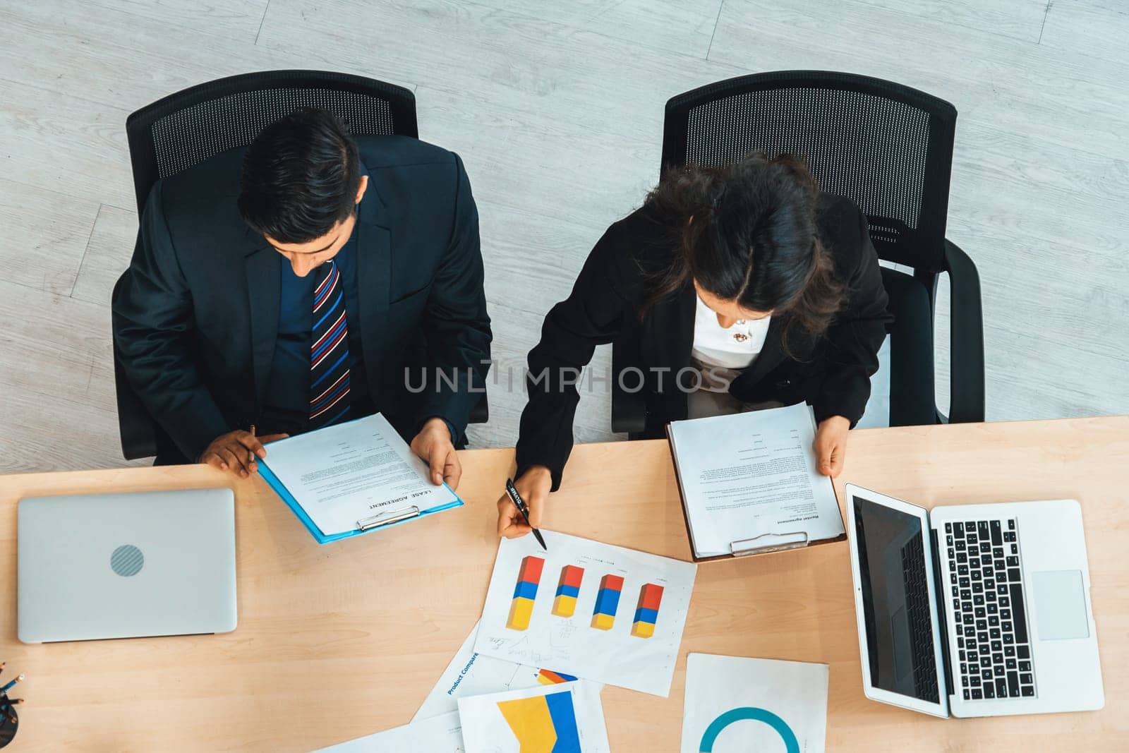 Business people group meeting shot from top view in office . Profession businesswomen, businessmen and office workers working in team conference with project planning document on meeting table . Jivy