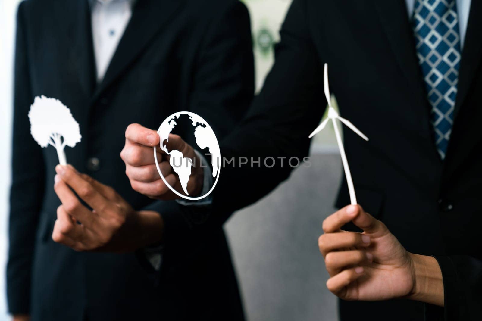 Group of business people holding alternative net zero energy icon for greener sustainable Earth with renewable energy technology to reduce CO2 emission. Quaint