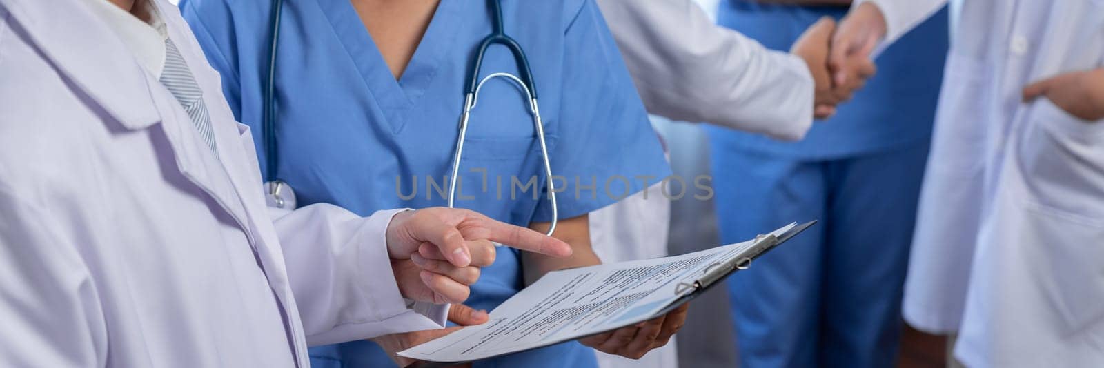 Medical staff team with doctor nurse and healthcare specialist professions working together with laptop and tablet in hospital. Medical workplace and healthcare community in panoramic banner. Neoteric