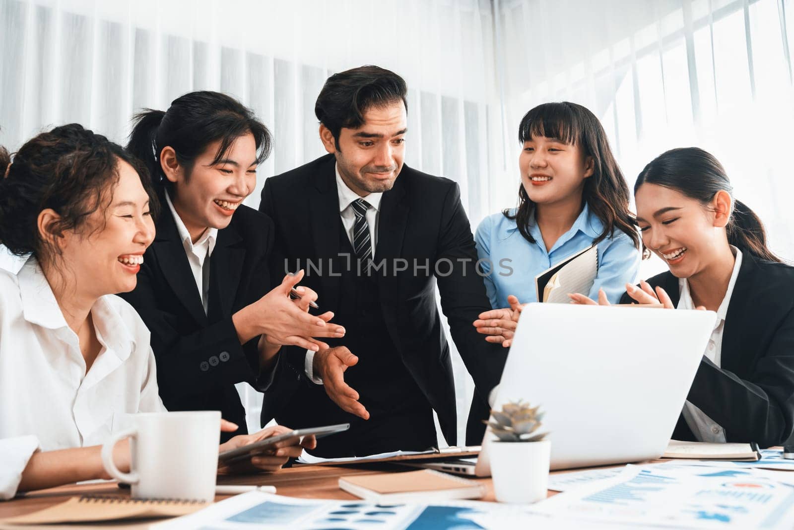 Diverse group of business analyst team analyzing financial data report paper on office table. Chart and graph dashboard by business intelligence analysis for strategic marketing planning Meticulous