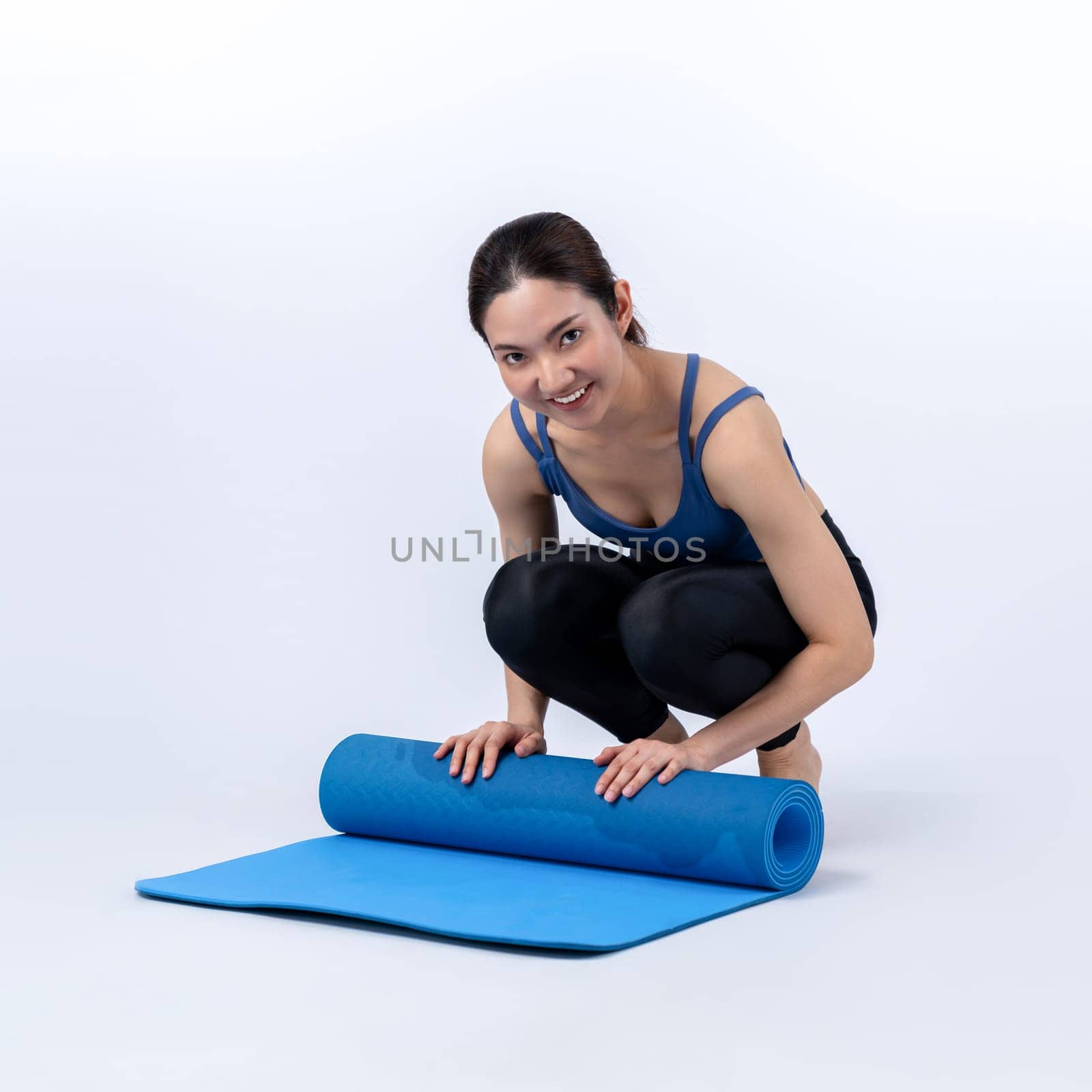 Young attractive asian woman portrait in sportswear with exercising mat. Healthy exercise and workout routine lifestyle concept. Studio shot isolated background. Vigorous