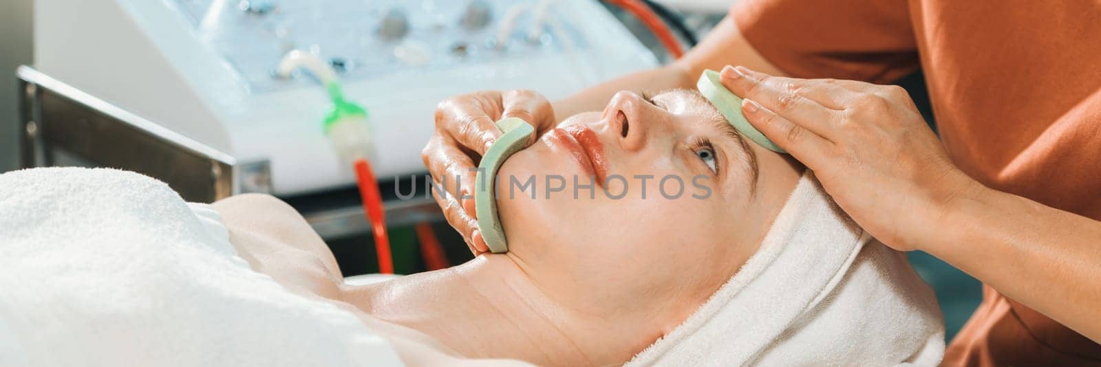 Attractive caucasian woman receive electrical facial treatment. Tranquility. by biancoblue