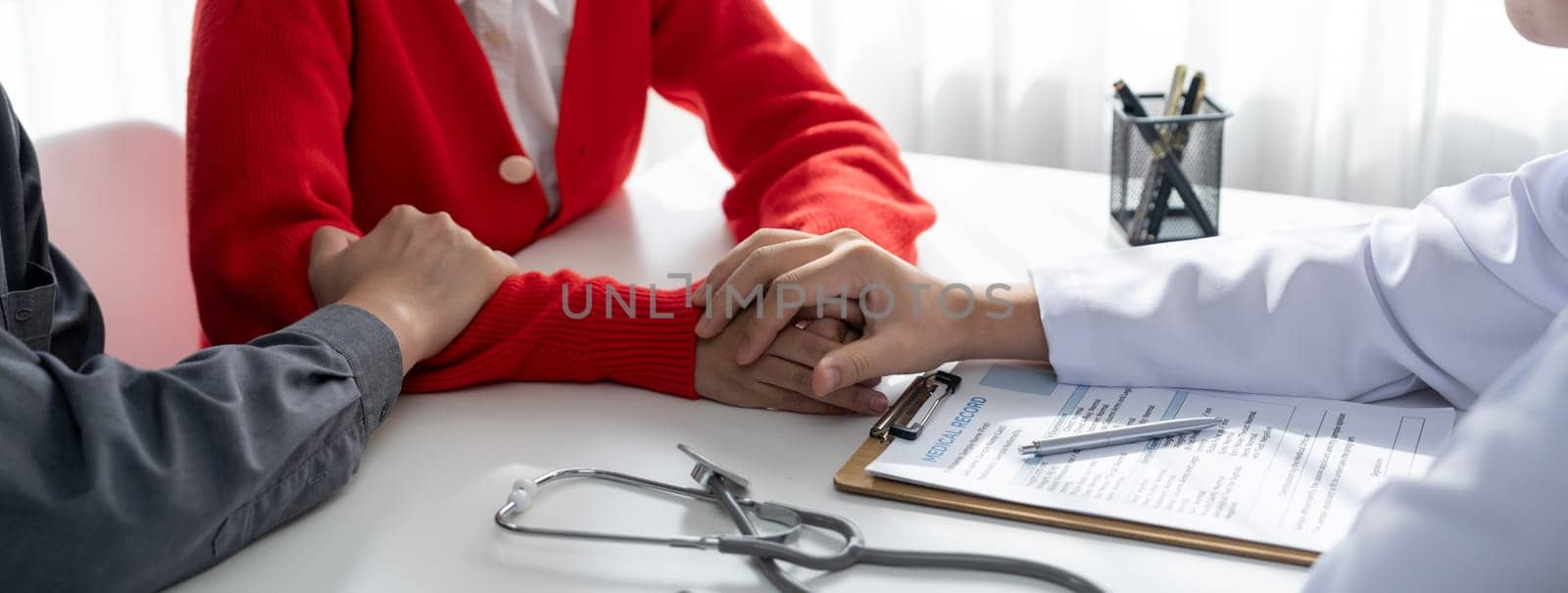 Couple attend fertility or medical consultation with gynecologist at hospital as family planning care for pregnancy. Husband and wife consoling each other through doctor appointment. Panorama Rigid