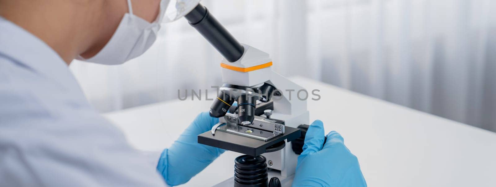 Laboratory researcher develop new medicine or cure using microscope. Technological advance of healthcare with scientific expertise with laboratory microbiology equipment. Panorama Rigid