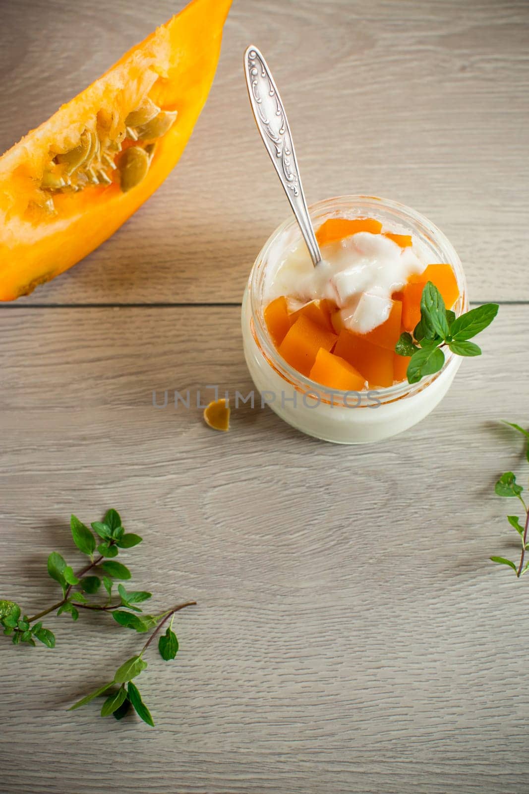 Homemade yogurt with pieces of pumpkin marmalade. Autumn recipes.