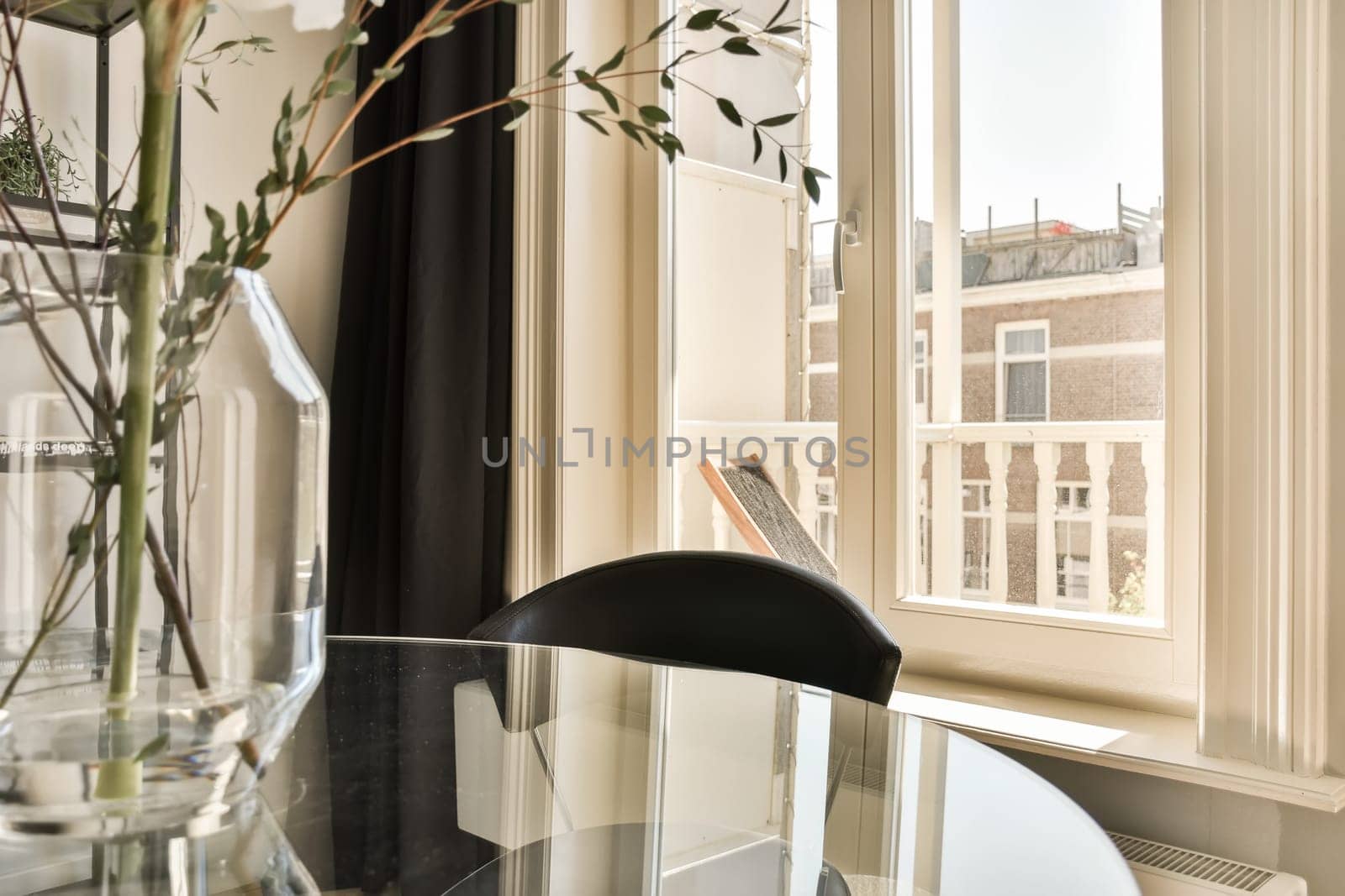 a dining table with a view of a window by casamedia