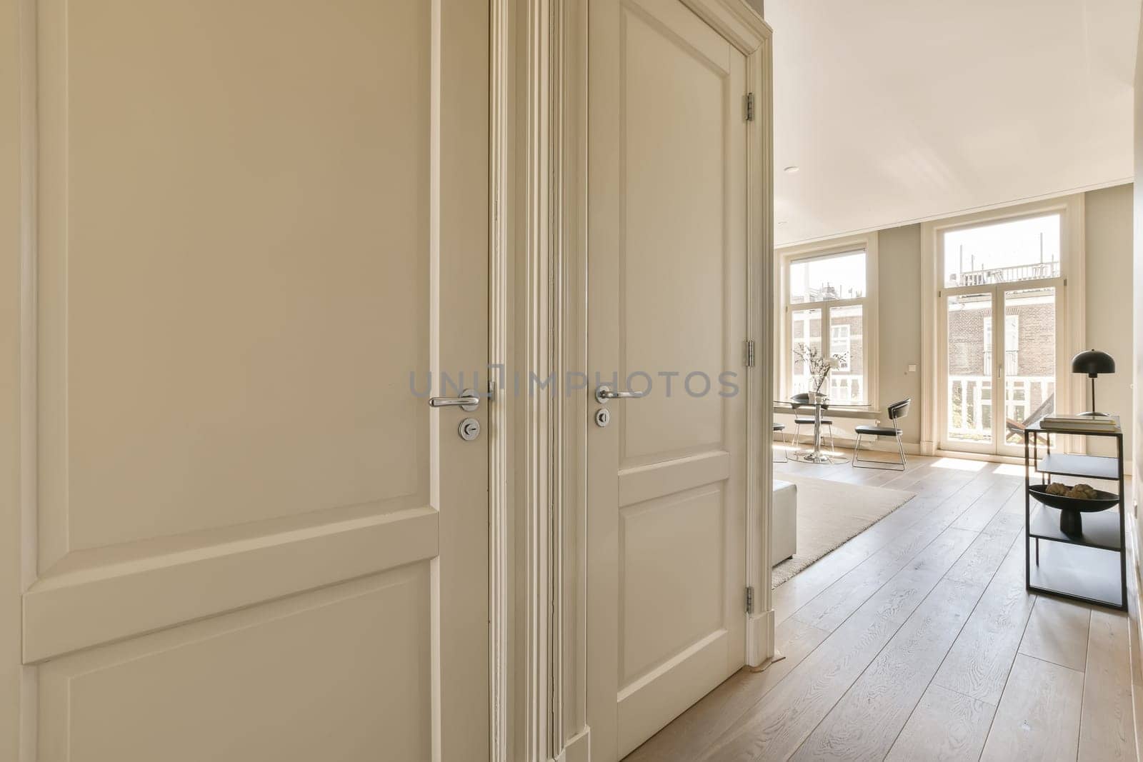 a large white door leading into a living room by casamedia