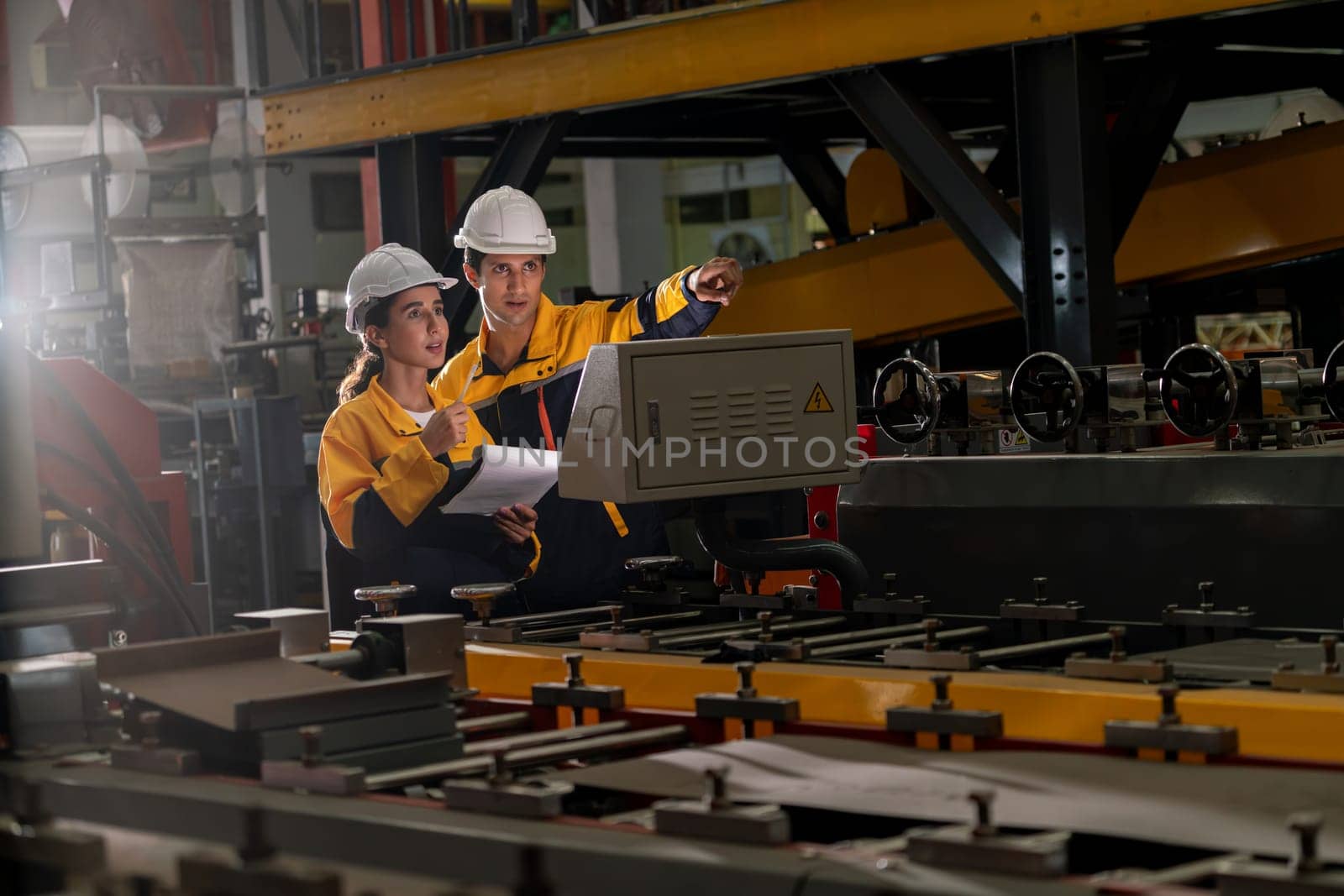 Professional quality control inspector conduct safety inspection on steel machinery and manufacturing process. Factory engineer or operator make optimization in heavy industry facility. Exemplifying