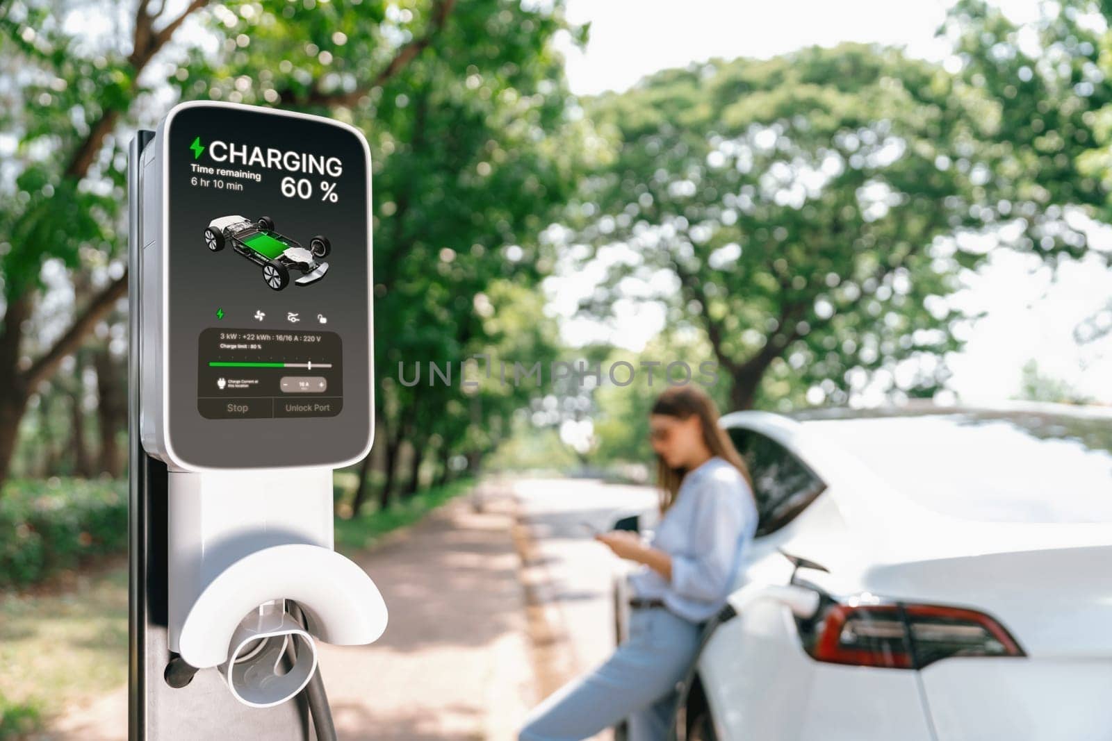 Young woman using smartphone to pay for electric car charging. Exalt by biancoblue