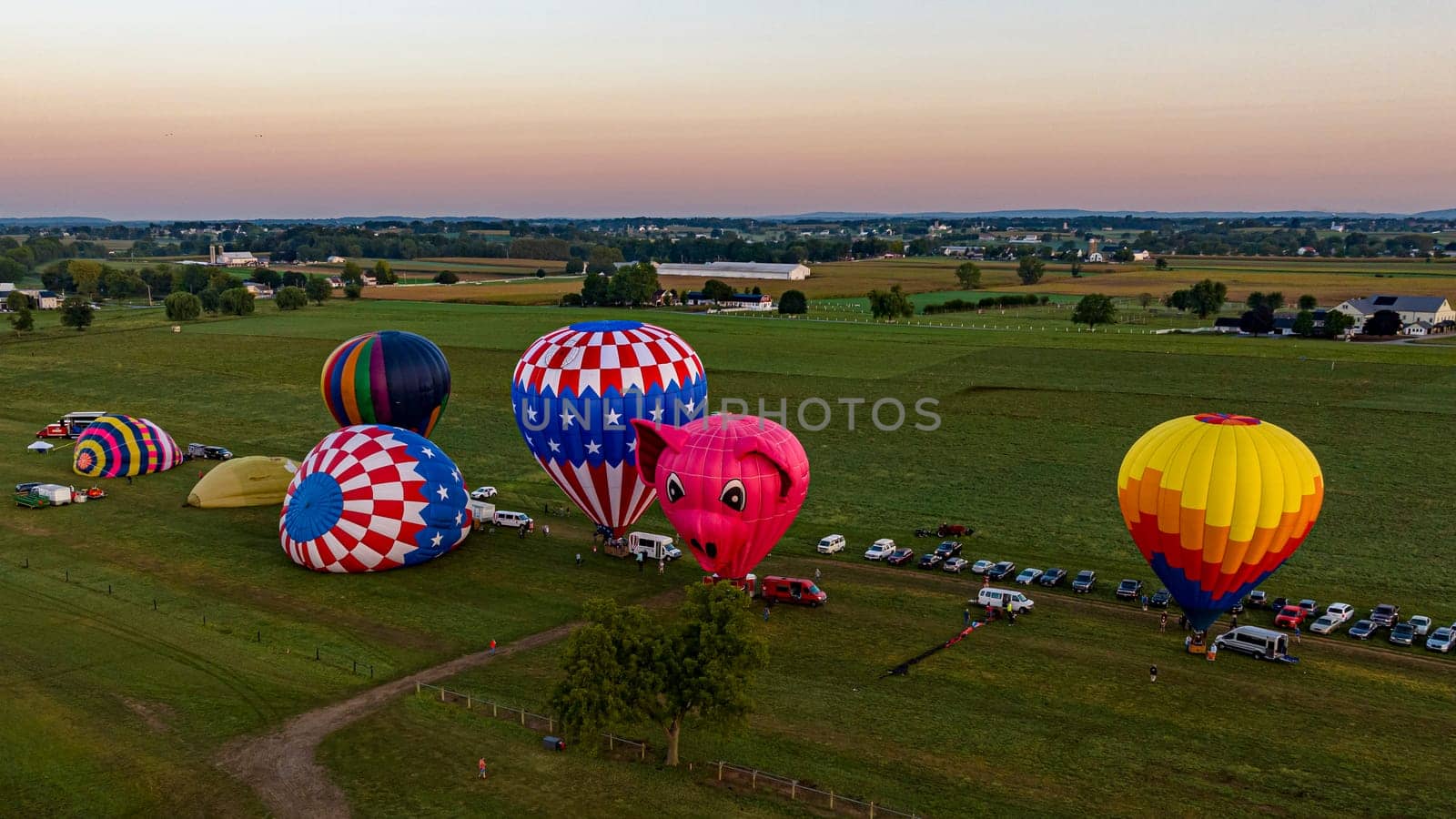 Bird in Hand, Pennsylvania, September 14, 2023 - An Aerial View of a Line of Hot Air Balloons Getting Ready for an Early Morning Launch, on a Summer Day