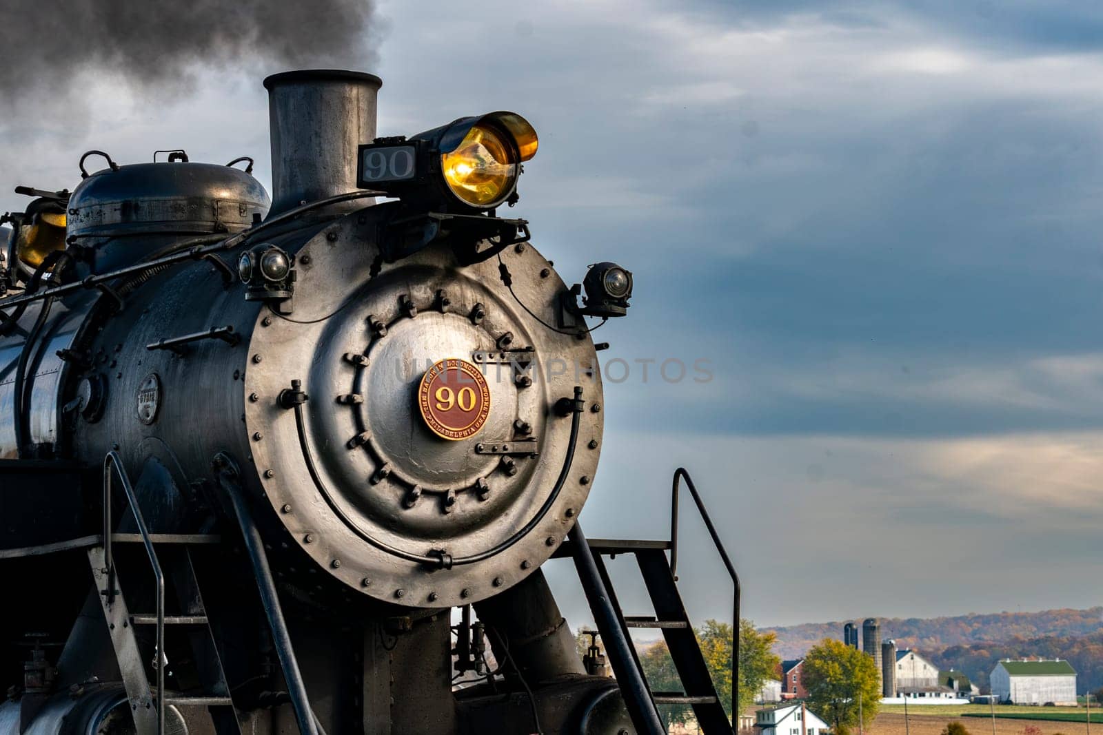 Ronks, Pennsylvania, November 4, 2023 - A Close Up View of the Front of an Antique Steam Locomotive Blowing Smoke