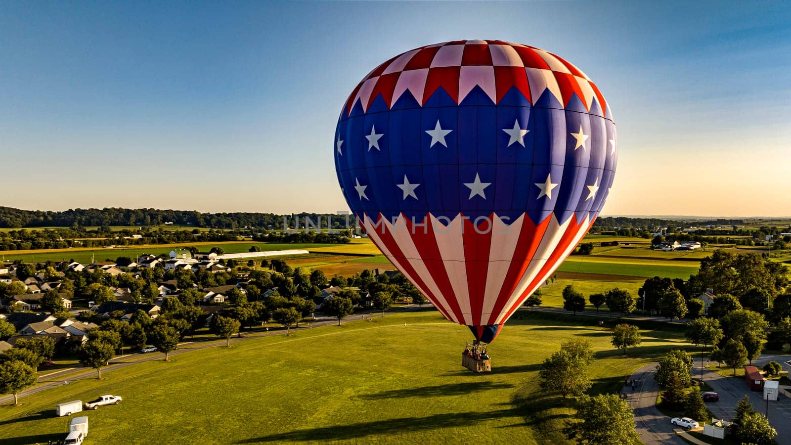 Bird in Hand, Pennsylvania, September 14, 2023 - An Aerial View on a Stars and Stripes, Hot Air Balloon Floating Over a Countryside Community, on a Beautiful Summer Day