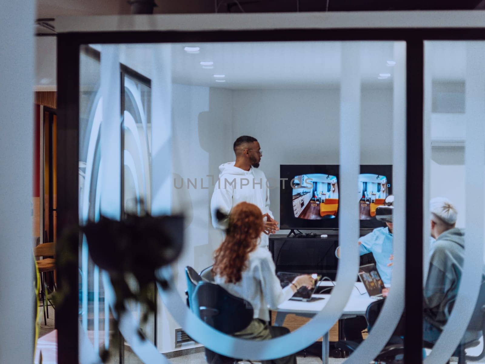 A diverse group of businessmen collaborates and tests a new virtual reality technology, wearing virtual glasses, showcasing innovation and creativity in their futuristic workspace by dotshock