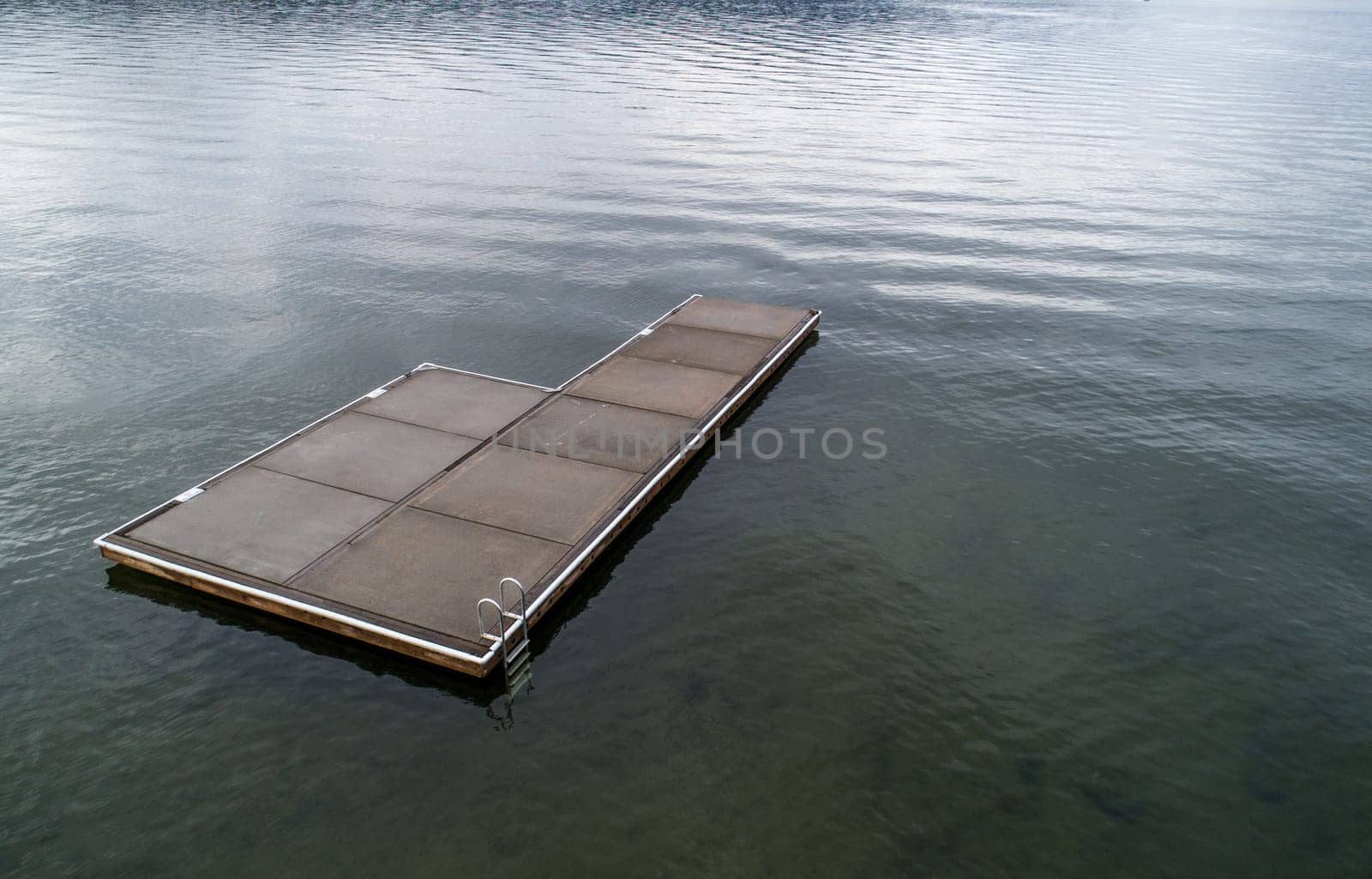 platform used for swimming in an empty lake during a cold day