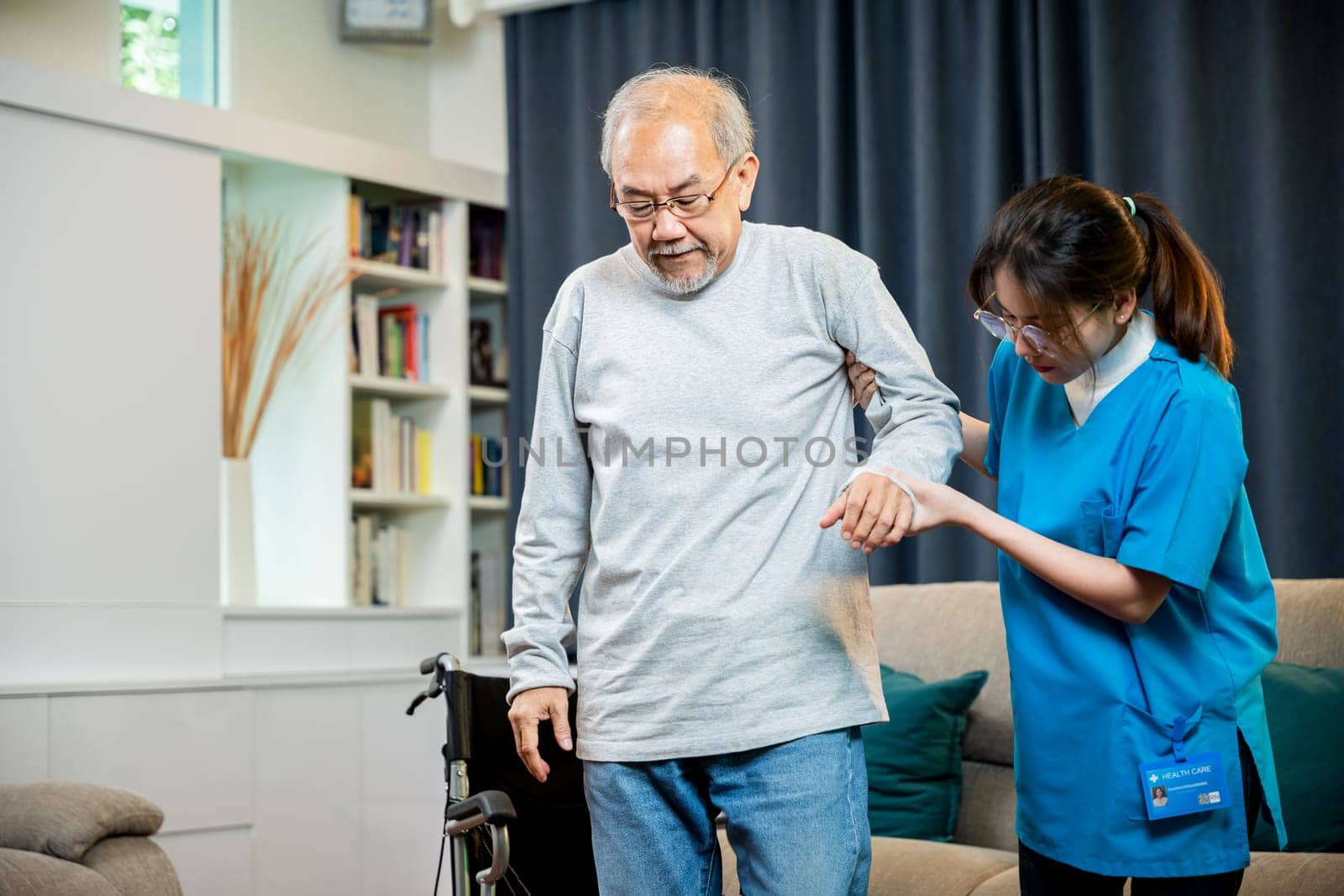 Asian doctor support old man to getting up to exercise by Sorapop