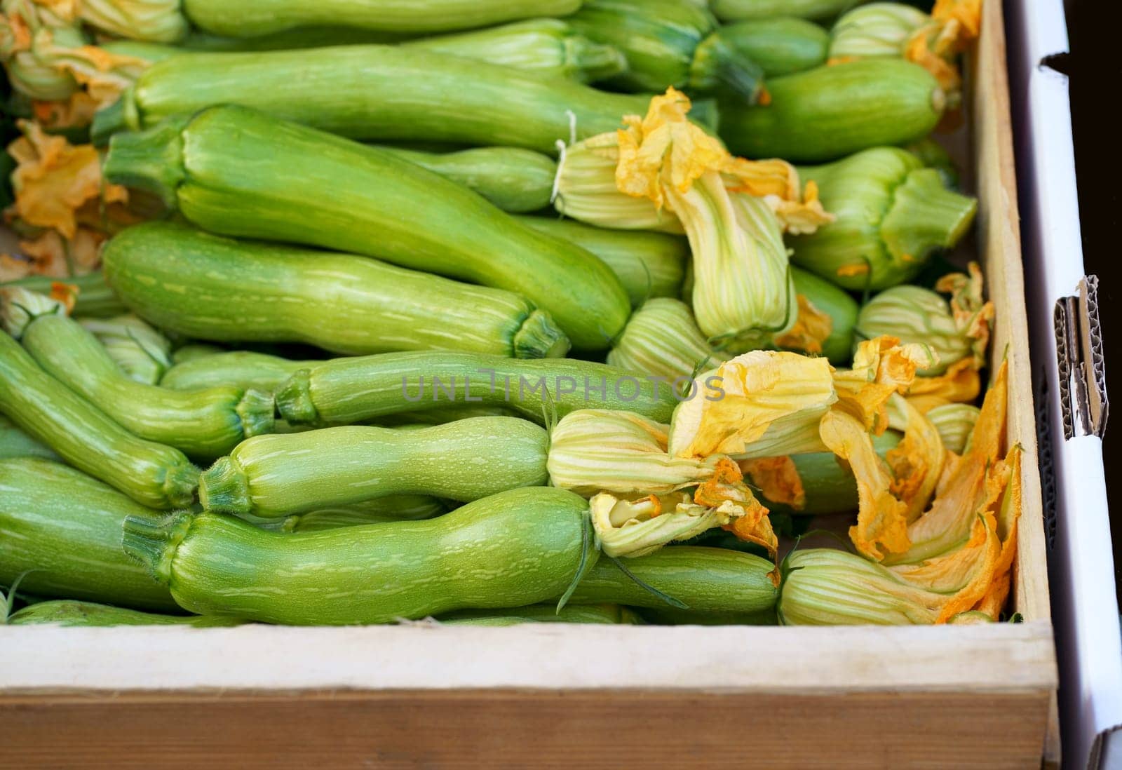 Nice. French market. Fresh zucchini with flowers sold at the market. Zucchini flowers are used in traditional French cuisine by aprilphoto