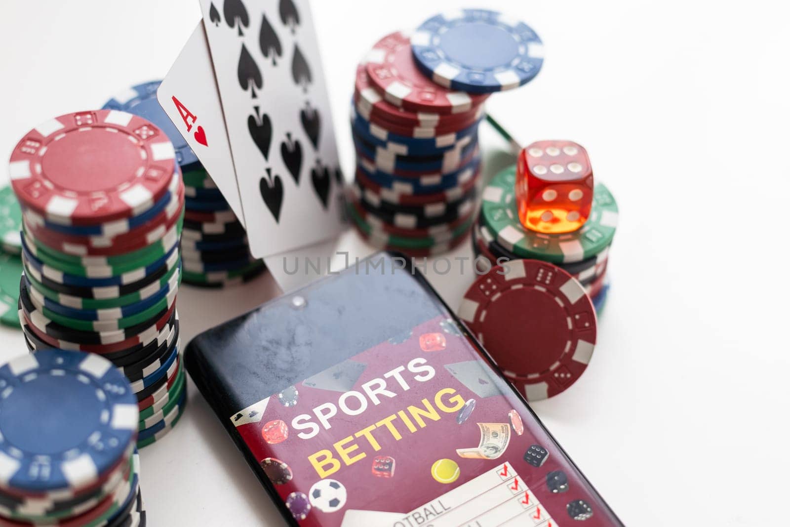 Creative background, online casino, in a smartphone with playing cards, roulette and chips, black-gold background. Internet gambling concept. Copy space. High quality photo