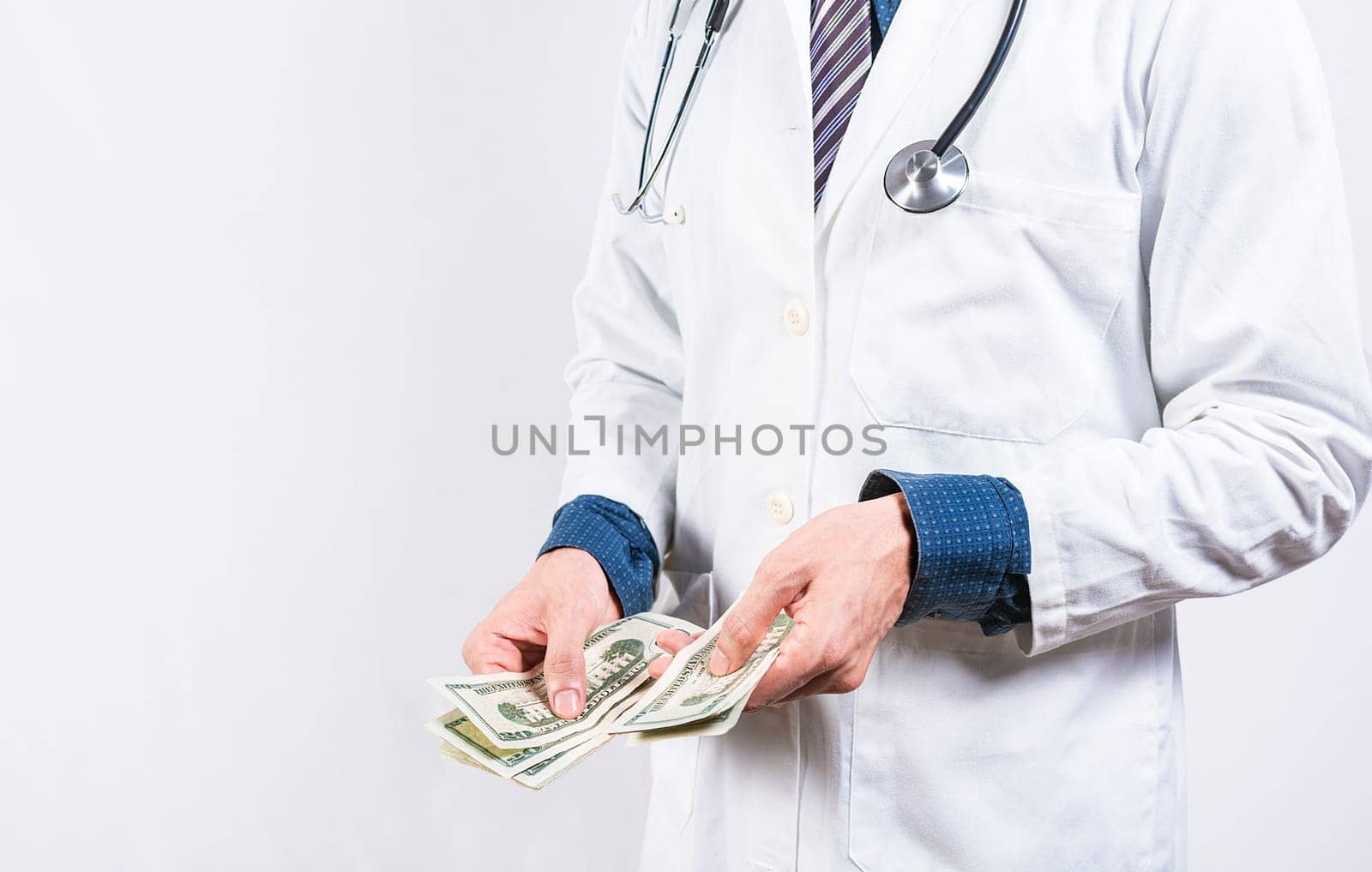 Corrupt doctor counting money isolated. hands of corrupt doctor counting money on isolated background, Medical corruption concept