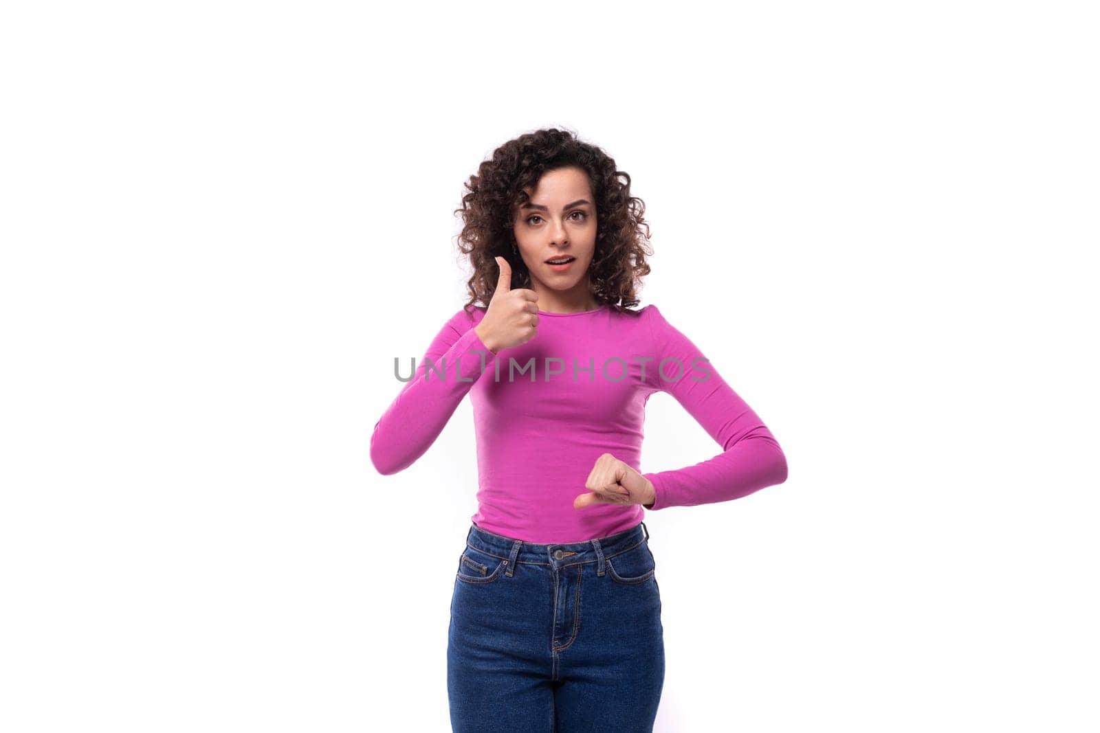 young caucasian woman with curly black hair on white background.