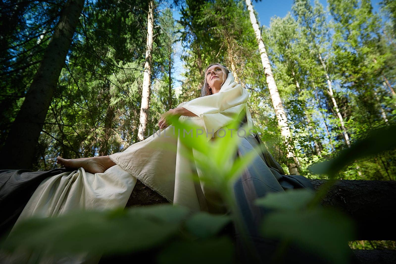 Beautiful seductive dryad. Pagan spirit of the forest. Portrait of beautiful dryad. Fairy who loves nature in beautiful green summer forest. Concept of environmental friendliness and caring for nature by keleny