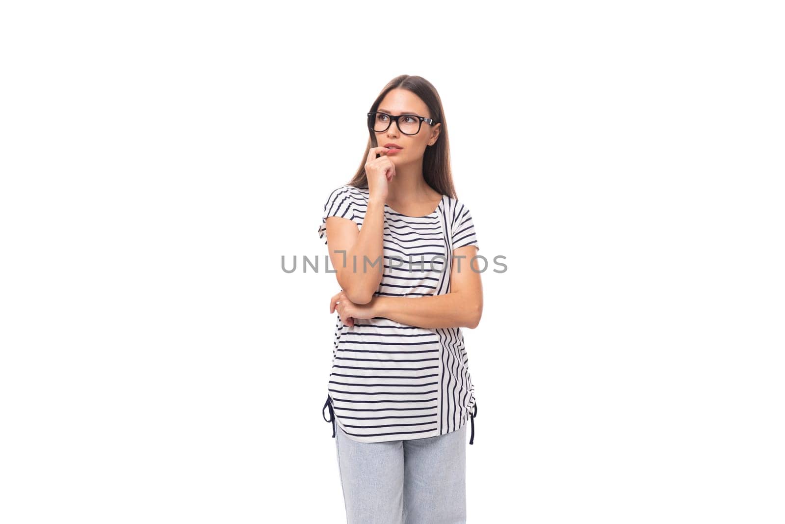 young well-groomed pleasant Caucasian brunette woman in a striped t-shirt posing on a white one with copy space.