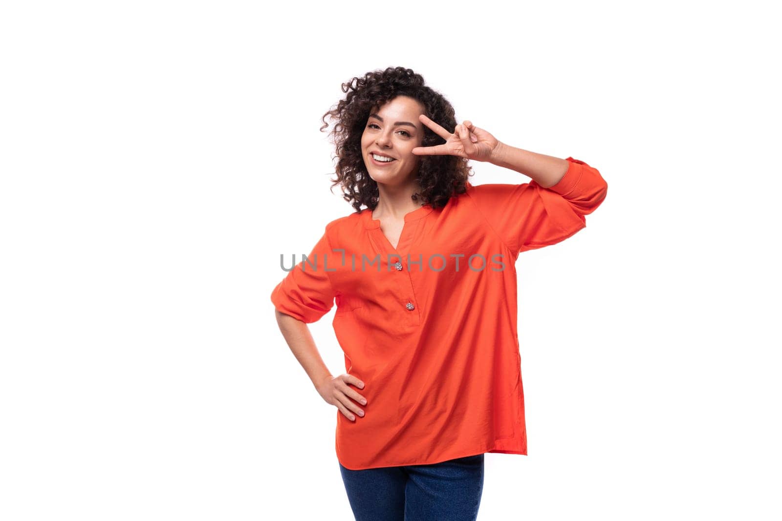 young cheerful caucasian lady with curly hair style dressed in orange shirt.