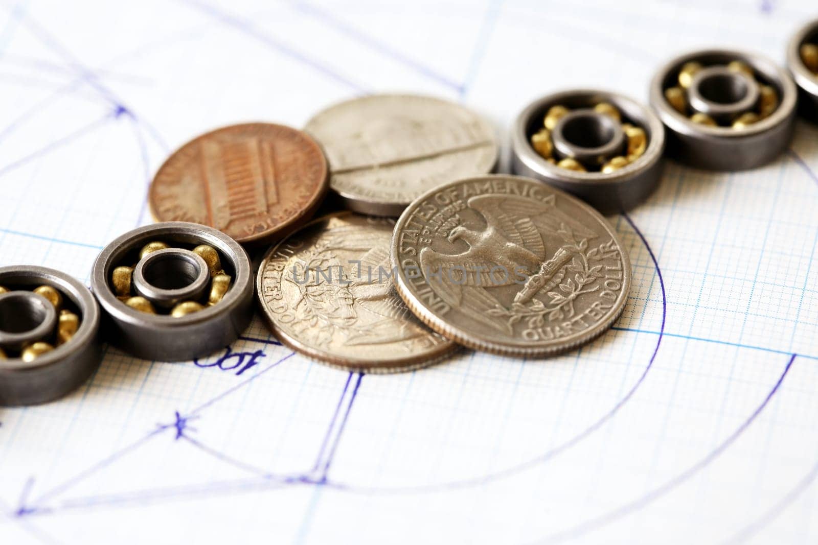 Business concept. Set of ball bearings  with coins on diagram background