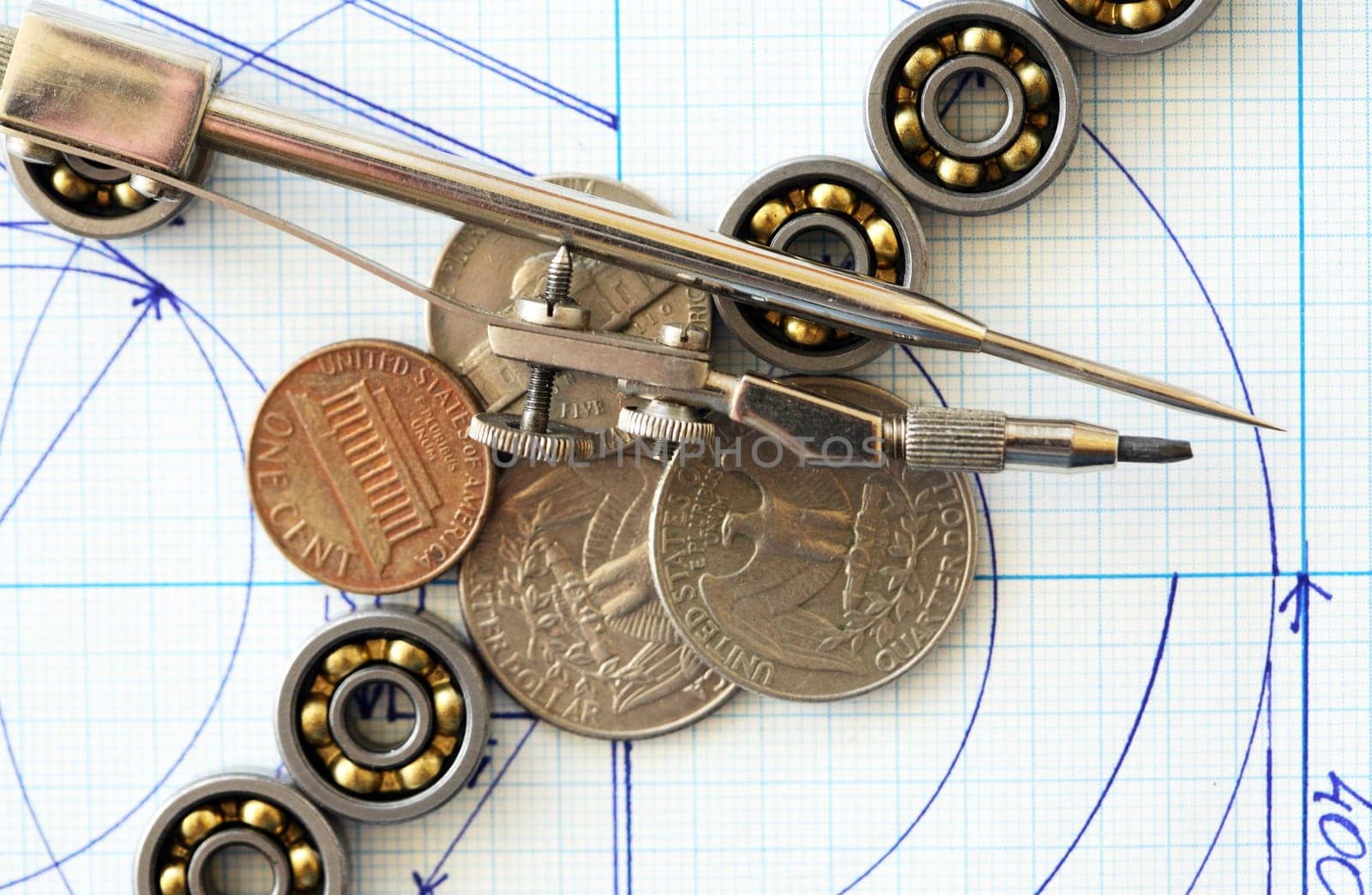 Business concept. Set of ball bearings  with coins on diagram background