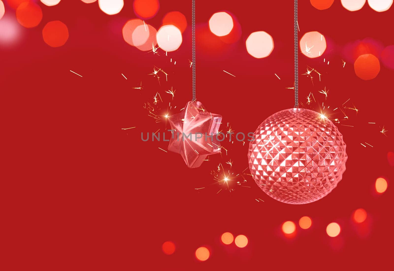 Christmas ball, star and lights on red background. Christmas and new year card. Copy space.