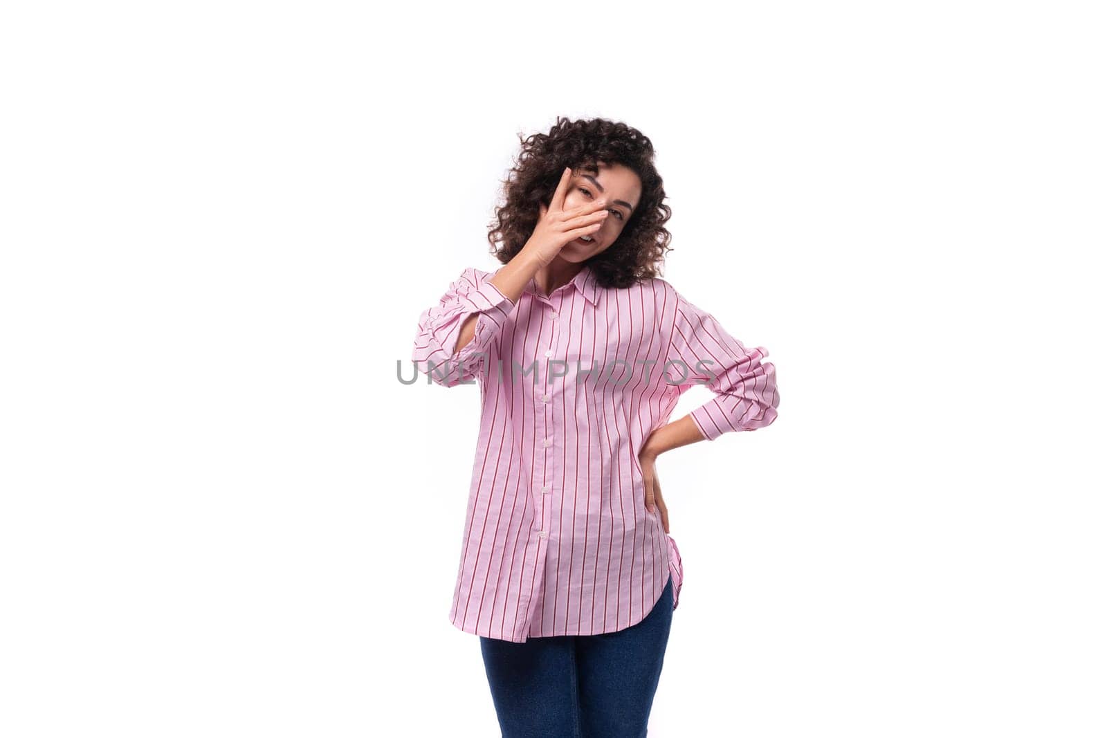 portrait of a young slender caucasian leader woman dressed in a pink striped oversized shirt.