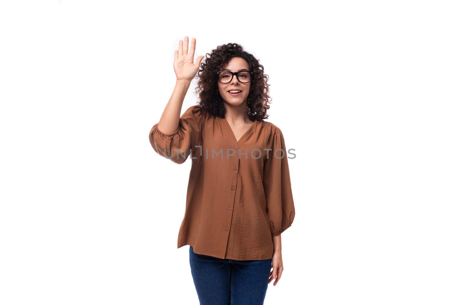 young successful stylish caucasian lady with black curly hair dressed in spring blouse by TRMK