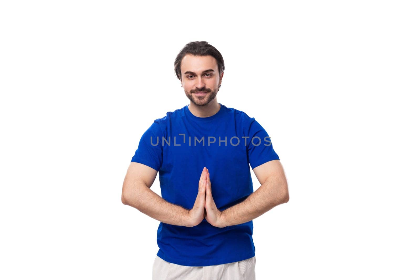 young smart handsome european man with black hair and beard dressed casually against the background with copy space by TRMK
