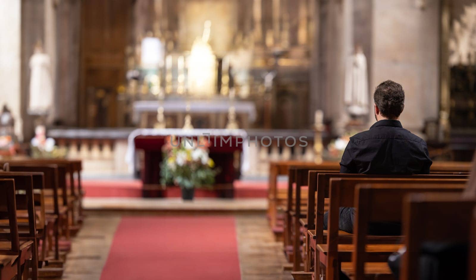 A man sitting in a church looking at the alter by Studia72