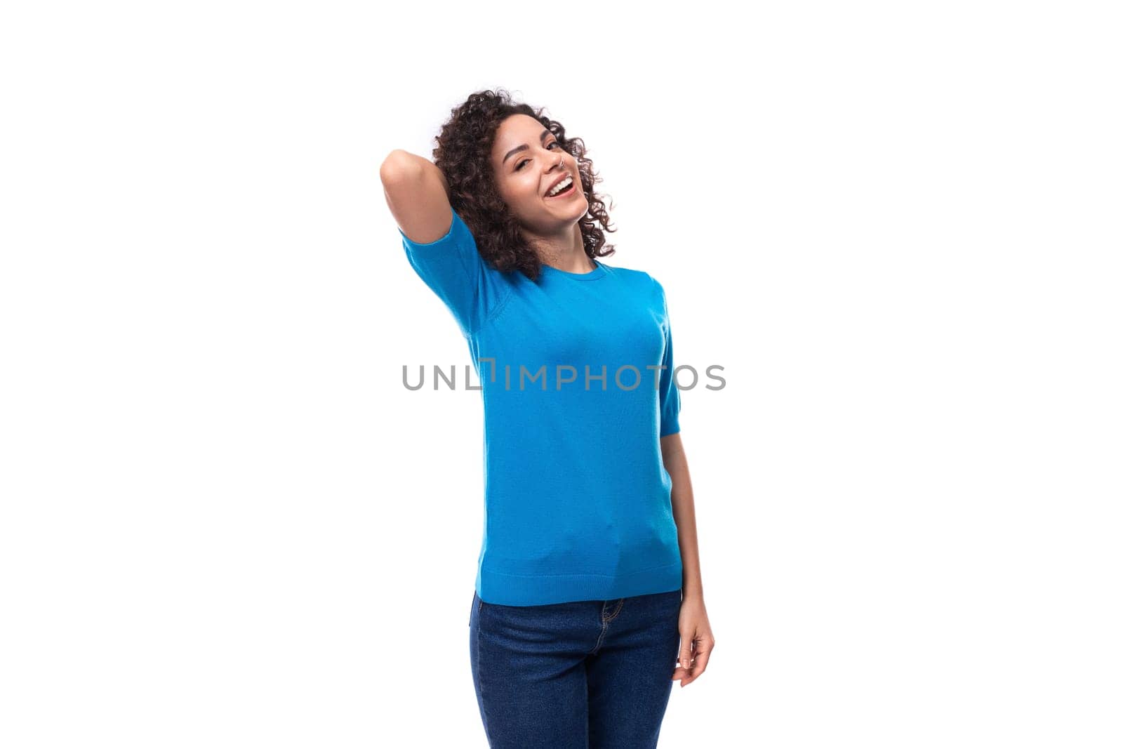 a young woman with a curly hairstyle above her shoulders is dressed in a blue summer blouse by TRMK