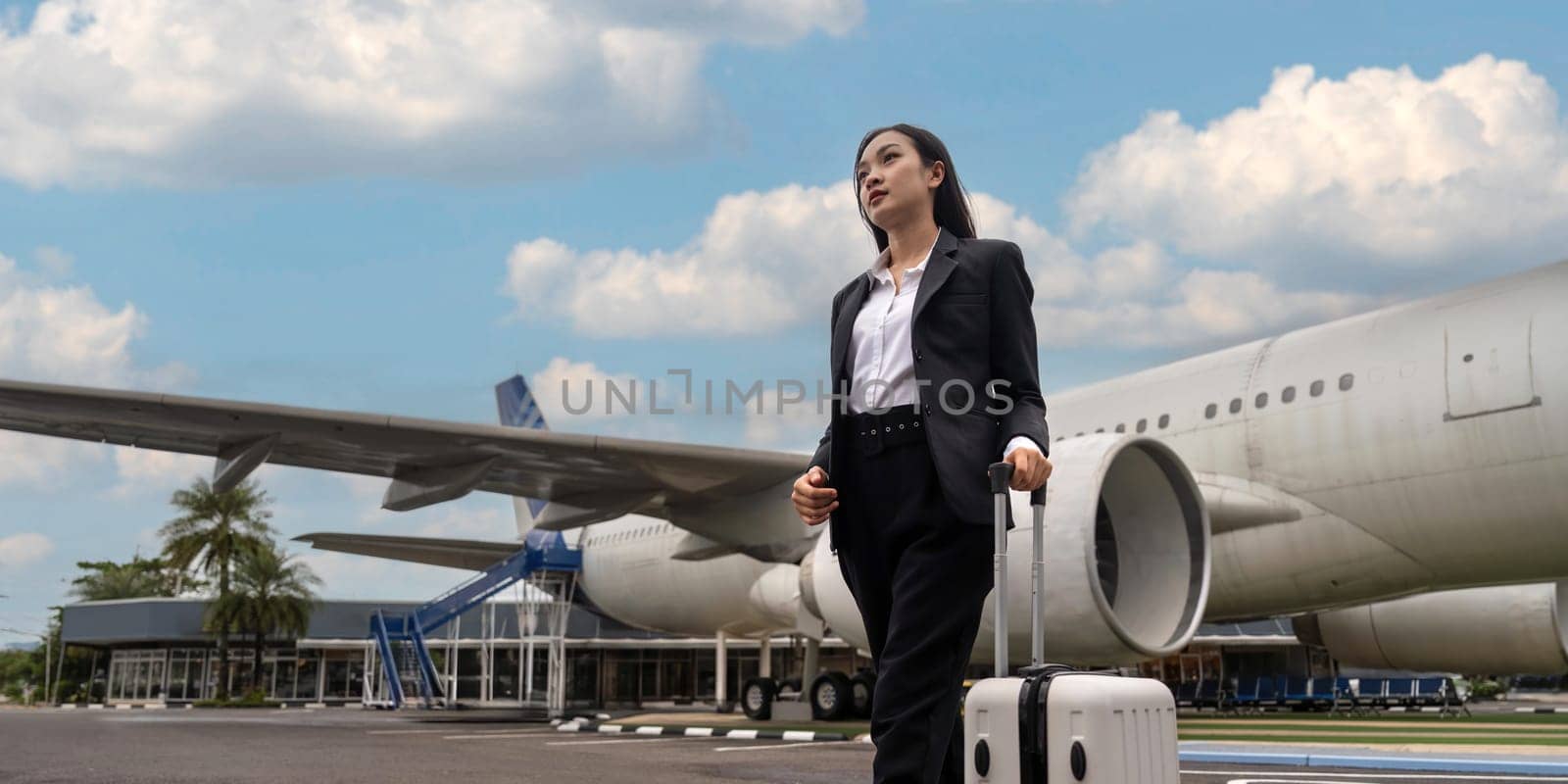 Tourist travel concept. young business woman holding the luggage at the airport.